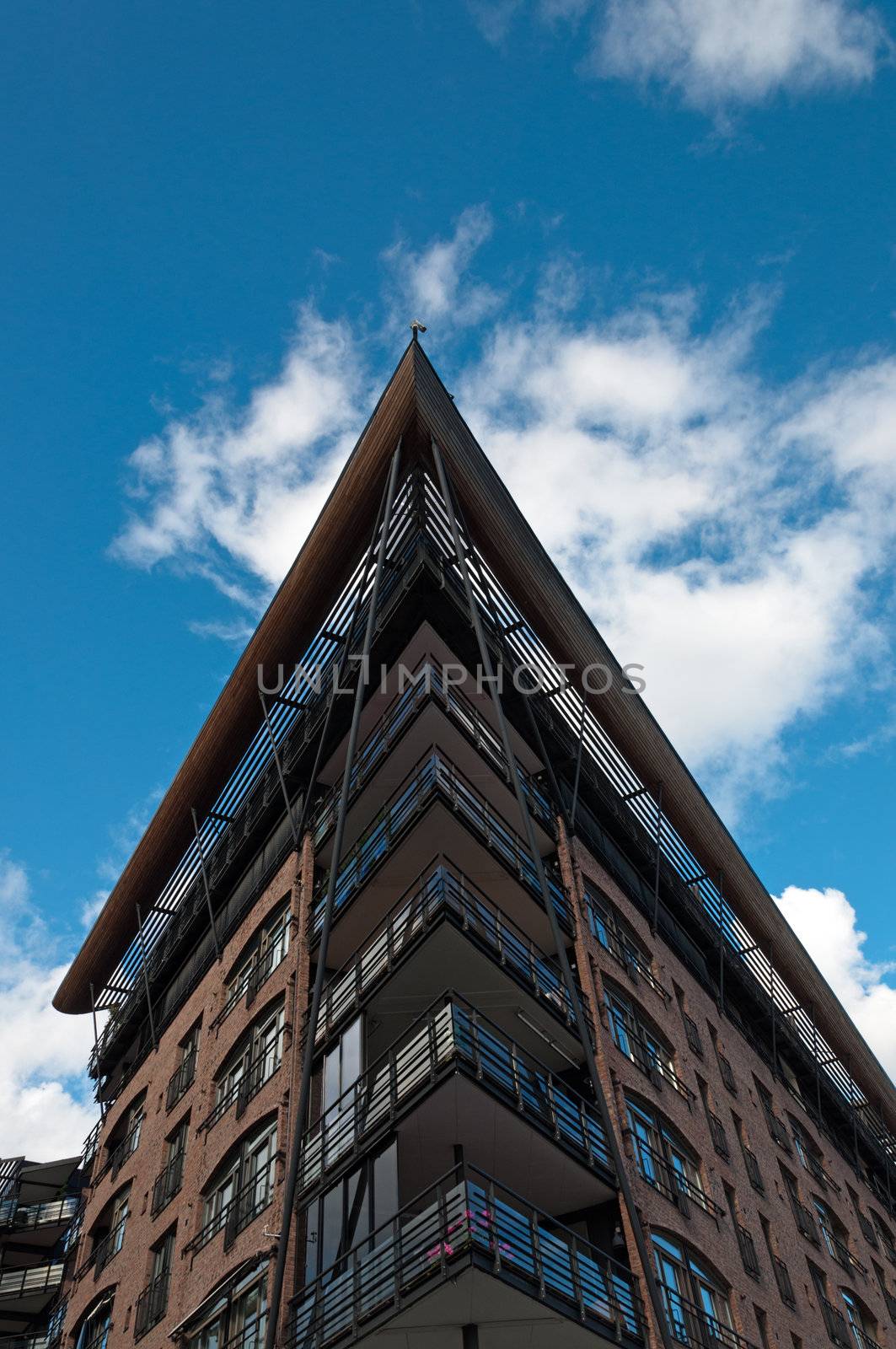 Big building with angled roof against the blue sky