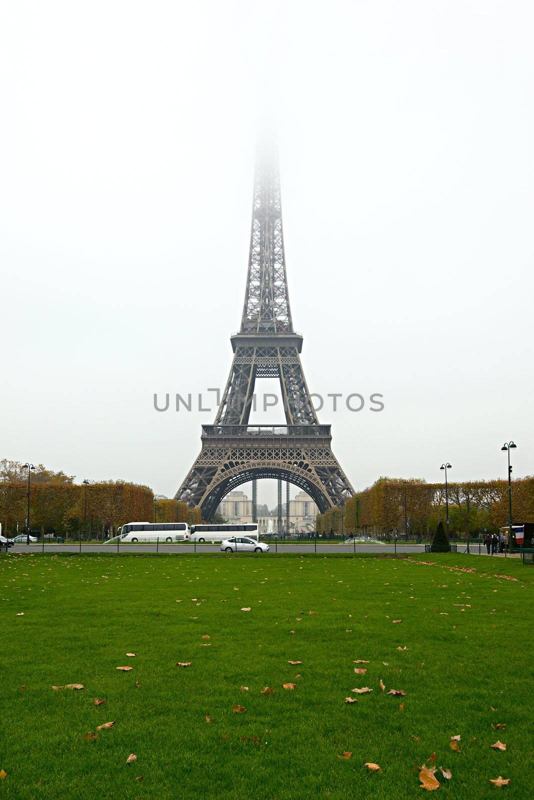 The Eiffel Tower with the top disappearing in the fog