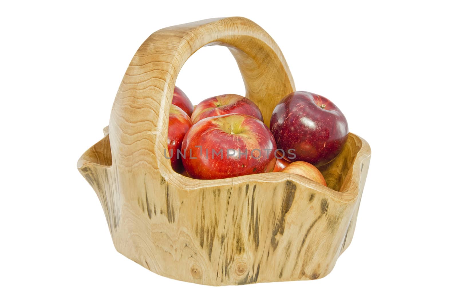 A wooden basket with apples isolated on white