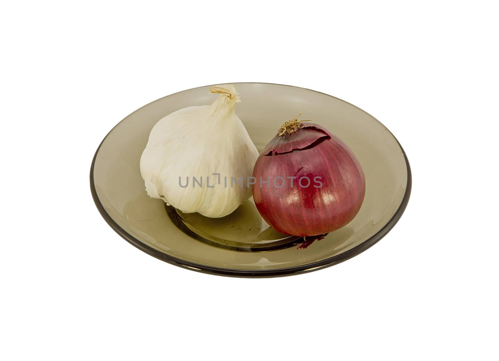 Two onions on a glass plate isolated on white