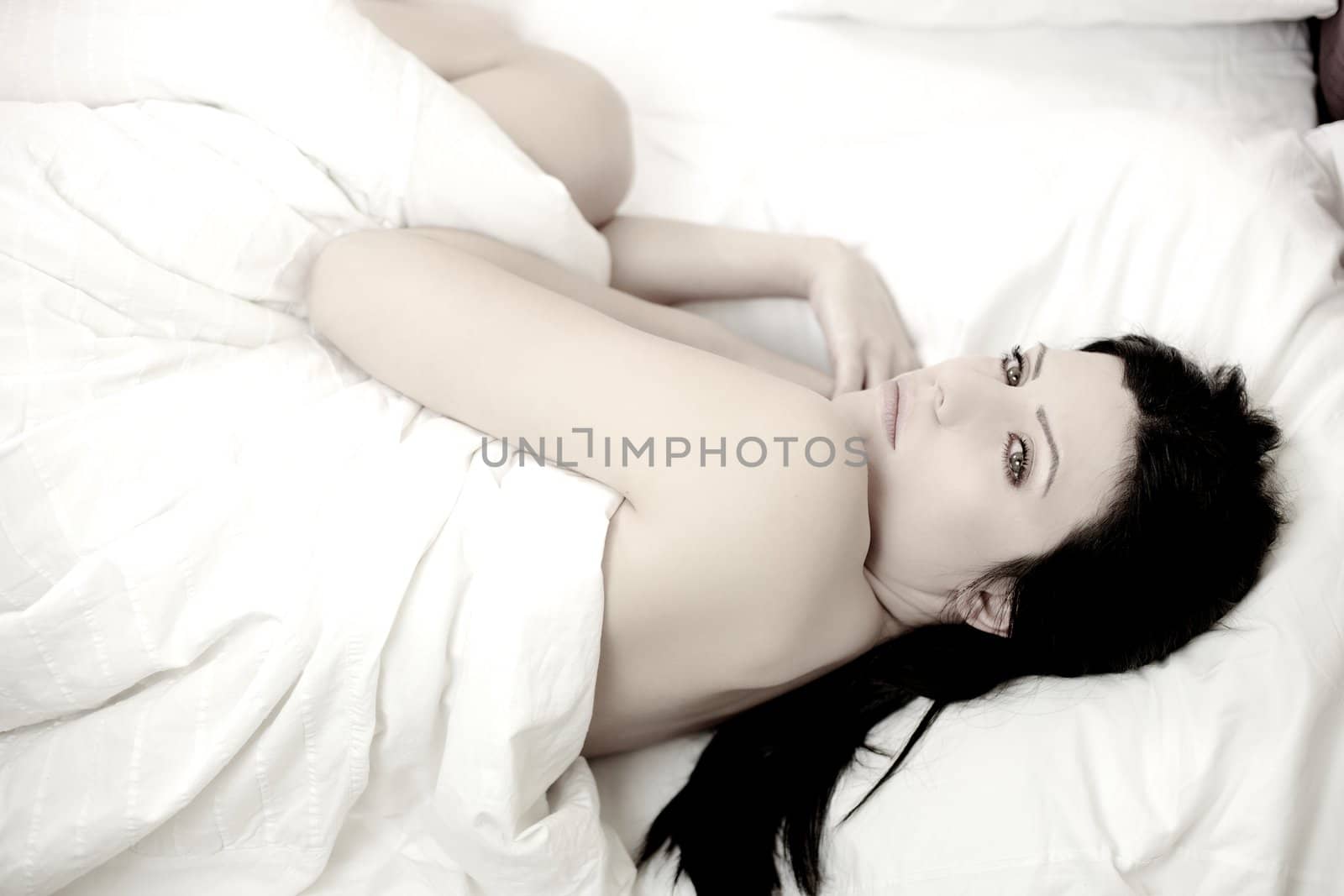 Portrait of naked beautiful woman in bed  by fmarsicano