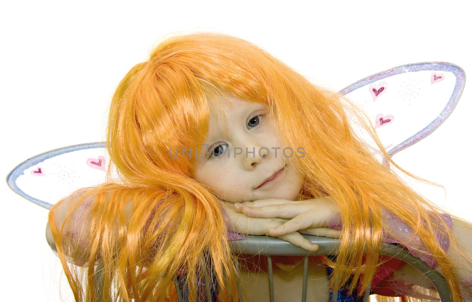 Girl in fancy dress and a wig on a white background