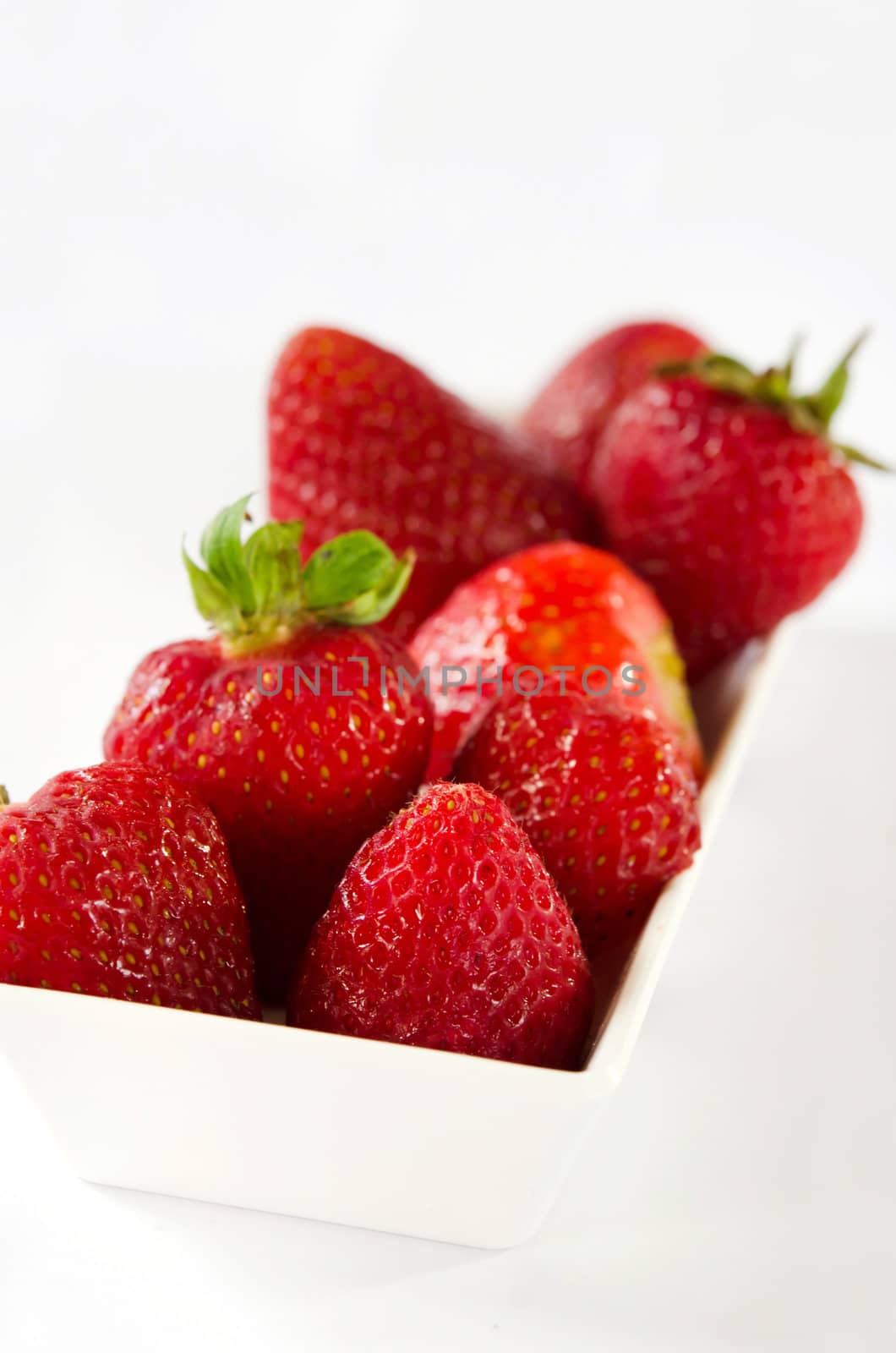 Strawberries berry fruits in white bowl