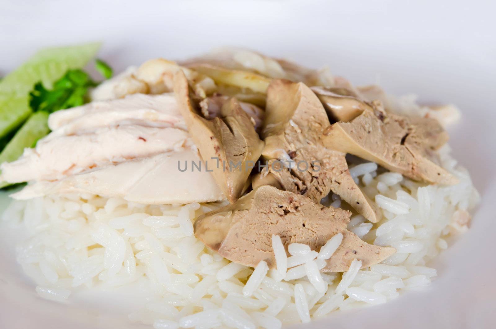  rice steamed with chicken soup served with  chicken and liver over rice and cucumber