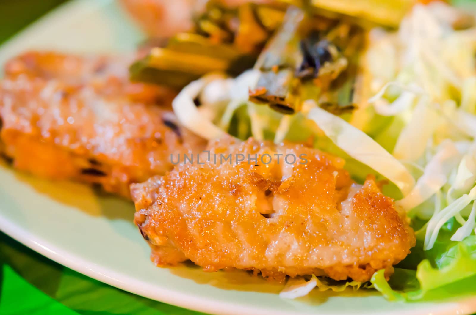deep fried chicken with fried garlic  and fresh vegetable