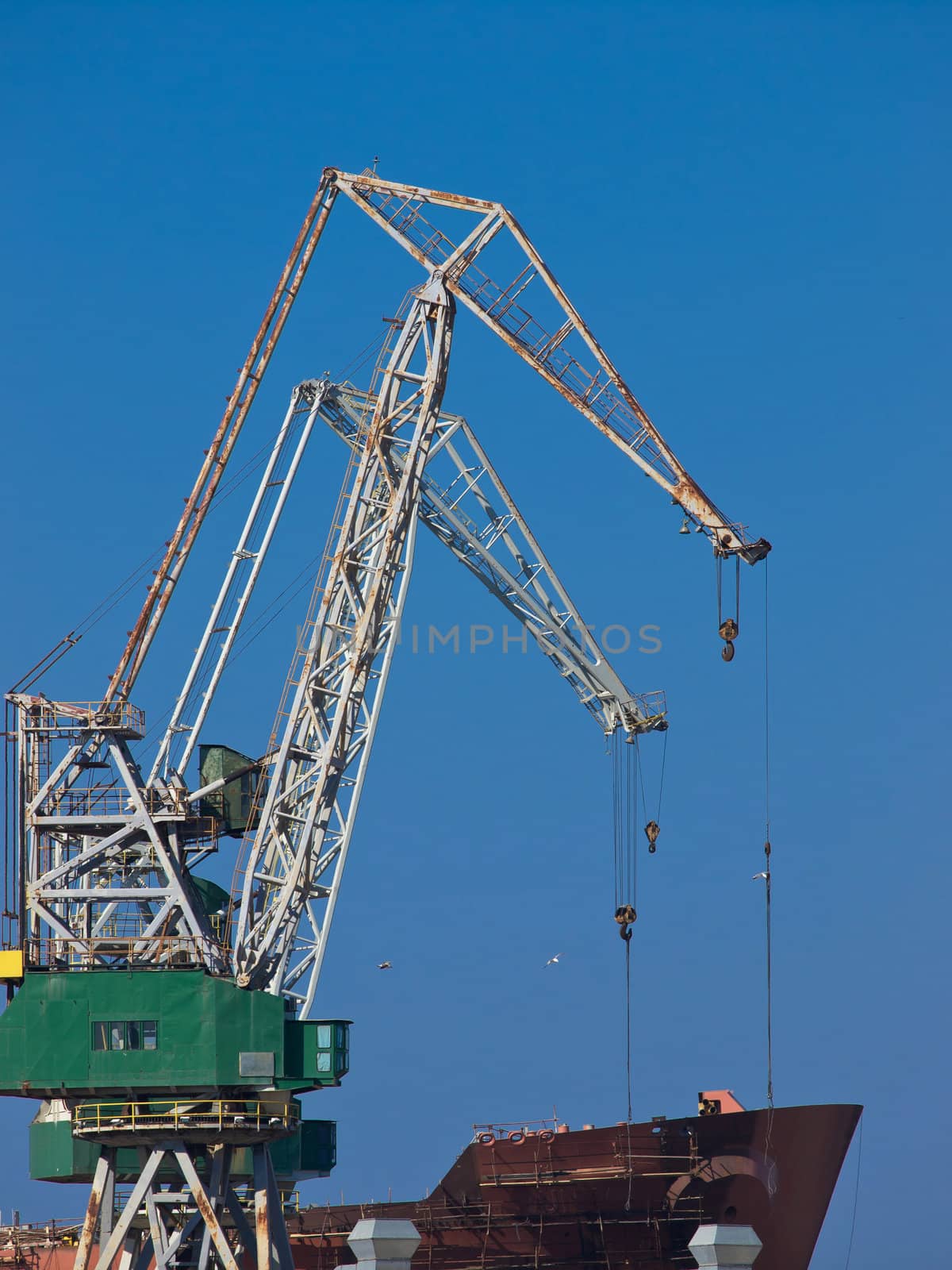cranes in the shipyard and a new boat