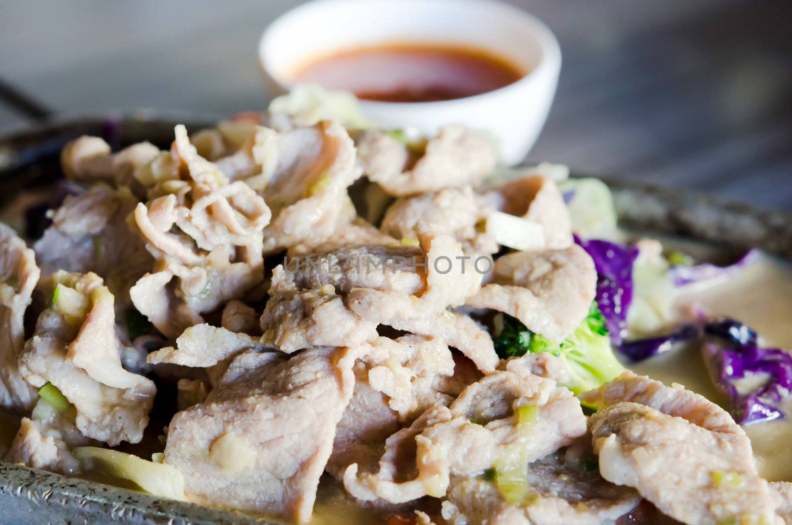 pork  fried with oyster sauce  and broccoli and cabbage served with spicy sauce