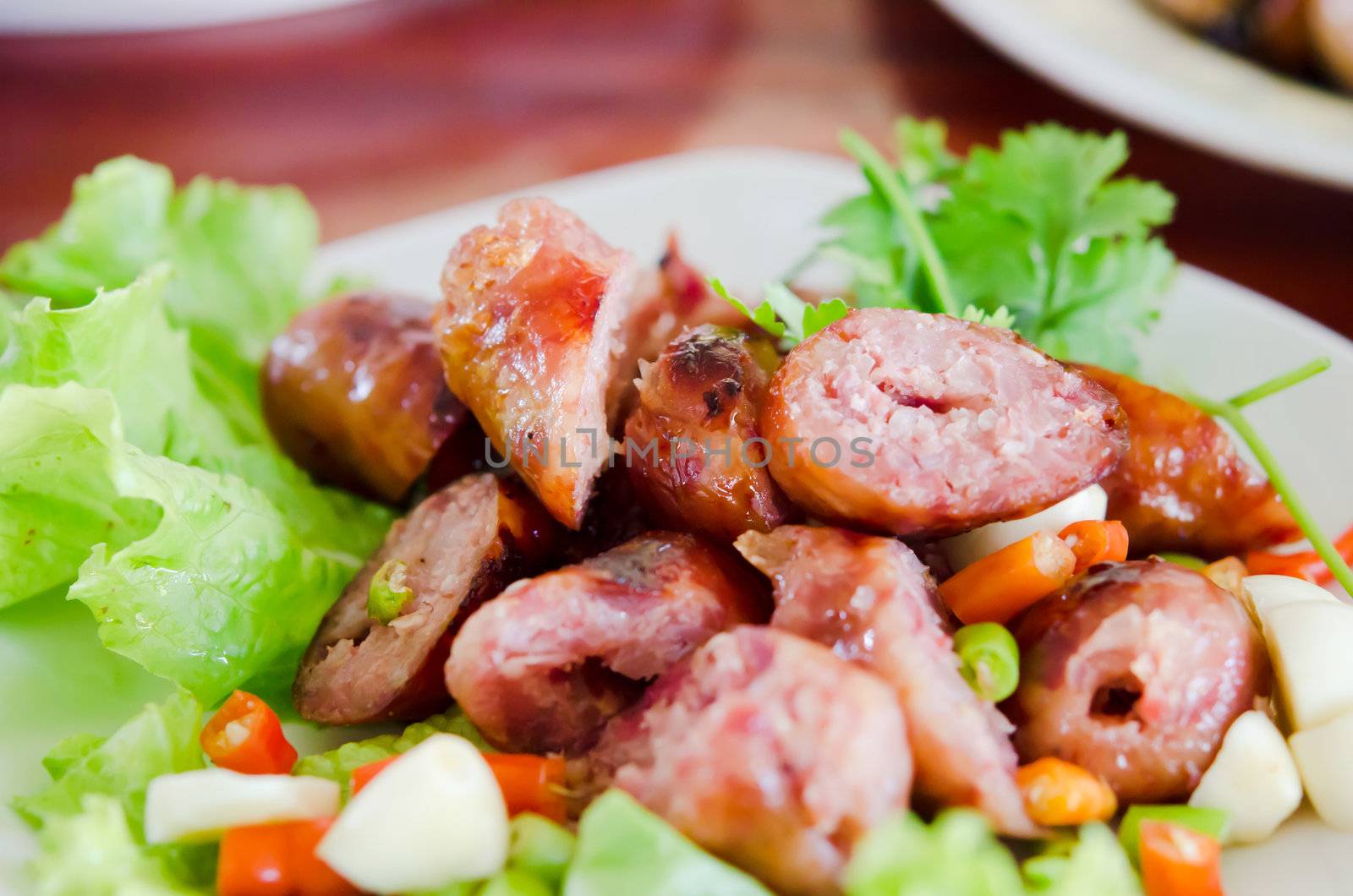 Thai Style Sausage served with chili , garlic and fresh vegetable
