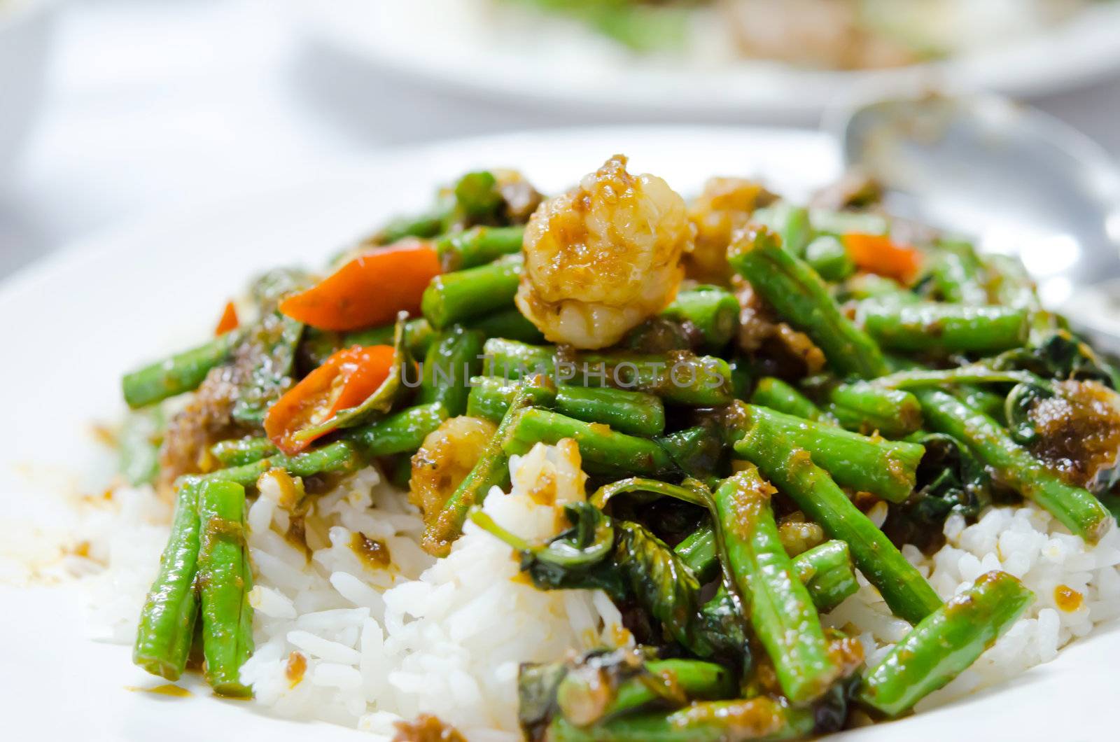stir fry  chinese cowpea and shrimp with curry sauce over rice