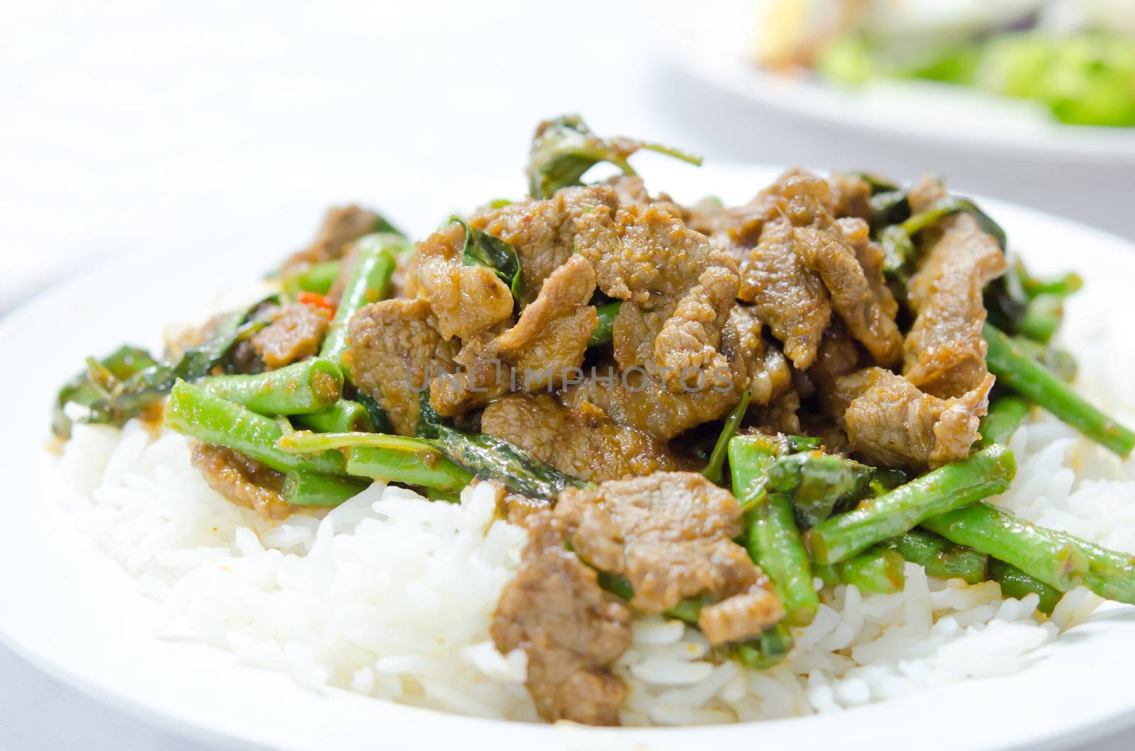 stir fry  chinese cowpea and pork with curry sauce over rice