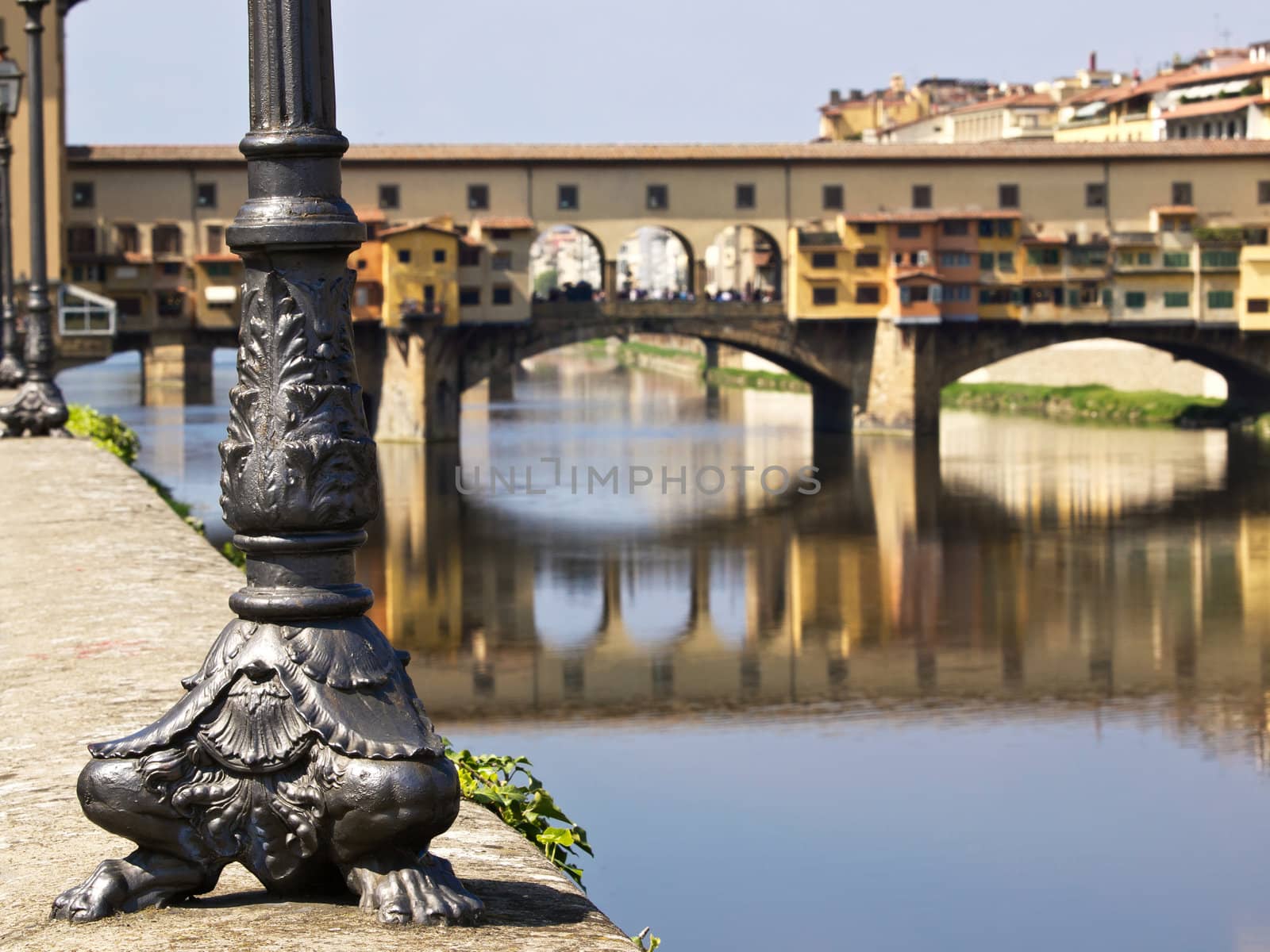 electric light post looking on the ponte vecchio bridge in Florence Italy