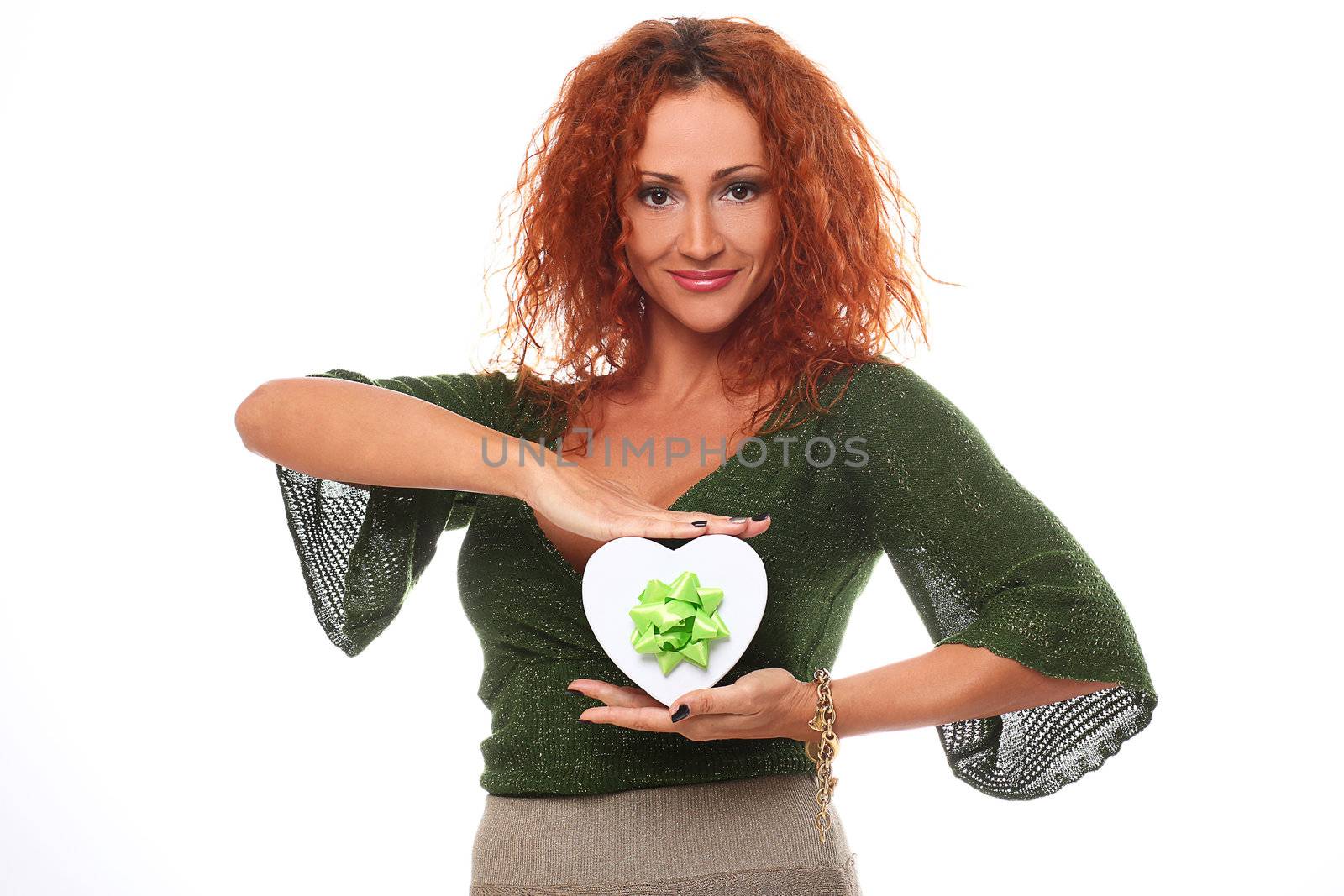 Beautiful redhead woman with gift in hands over a white background