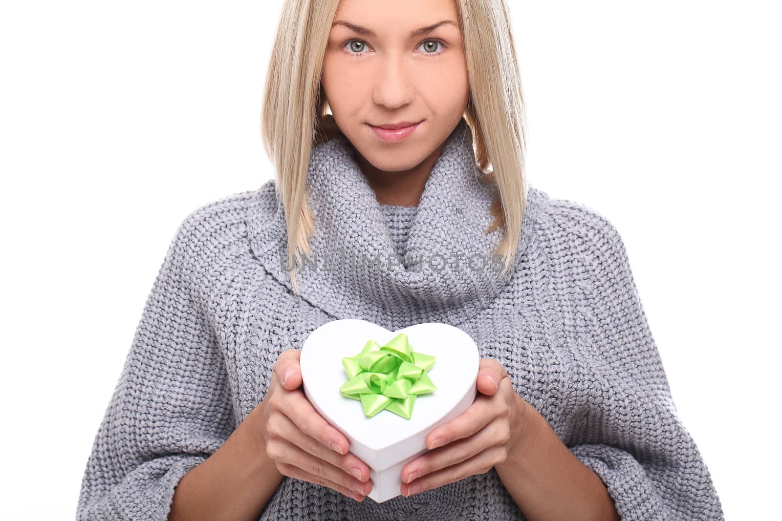 Attractive young woman with gift in hands over a white background