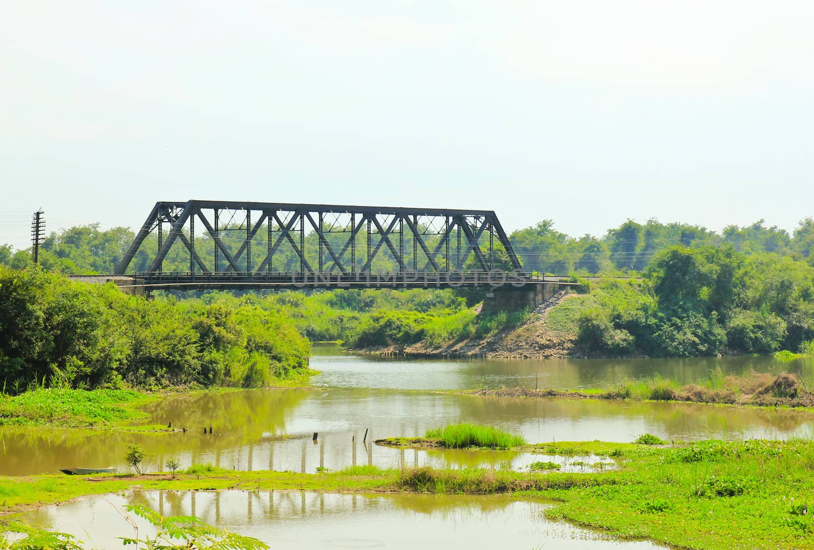 Ancient bridge over the river in Thailand