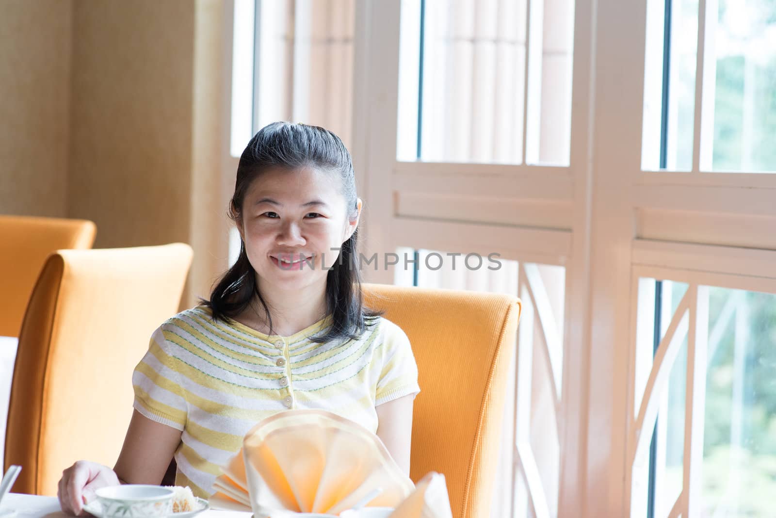 Asian Chinese 30s woman enjoying her meal in a restaurant