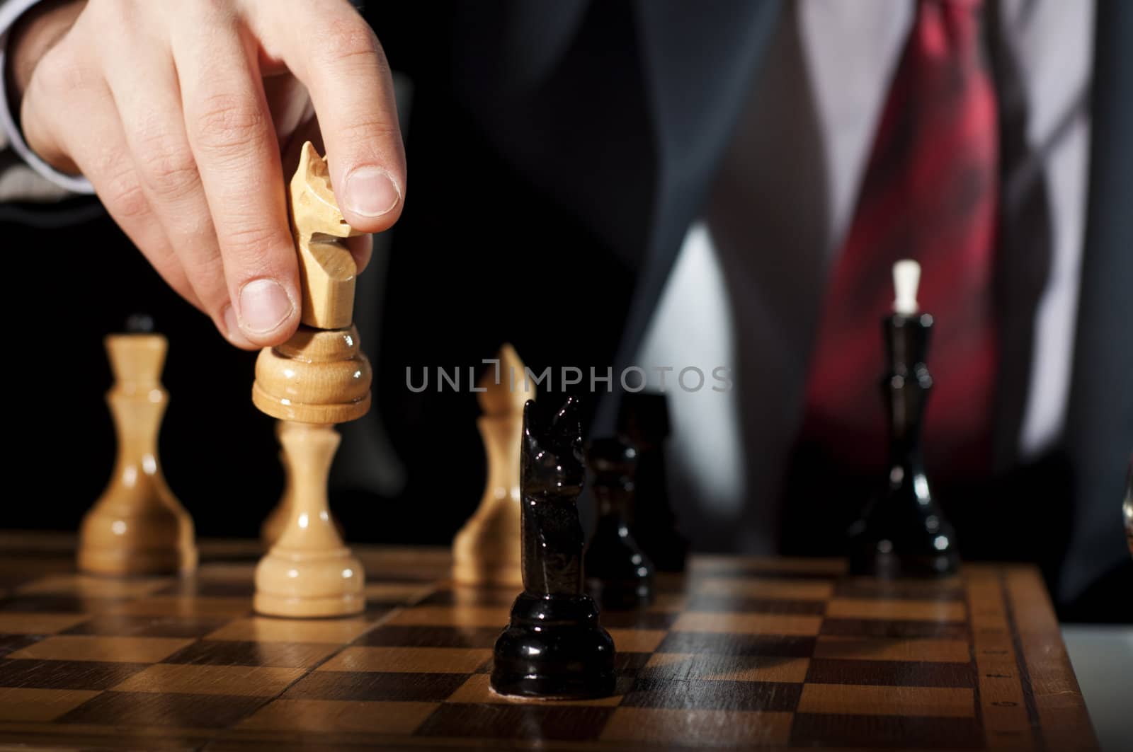 image of the businessman in a business suit plays chess