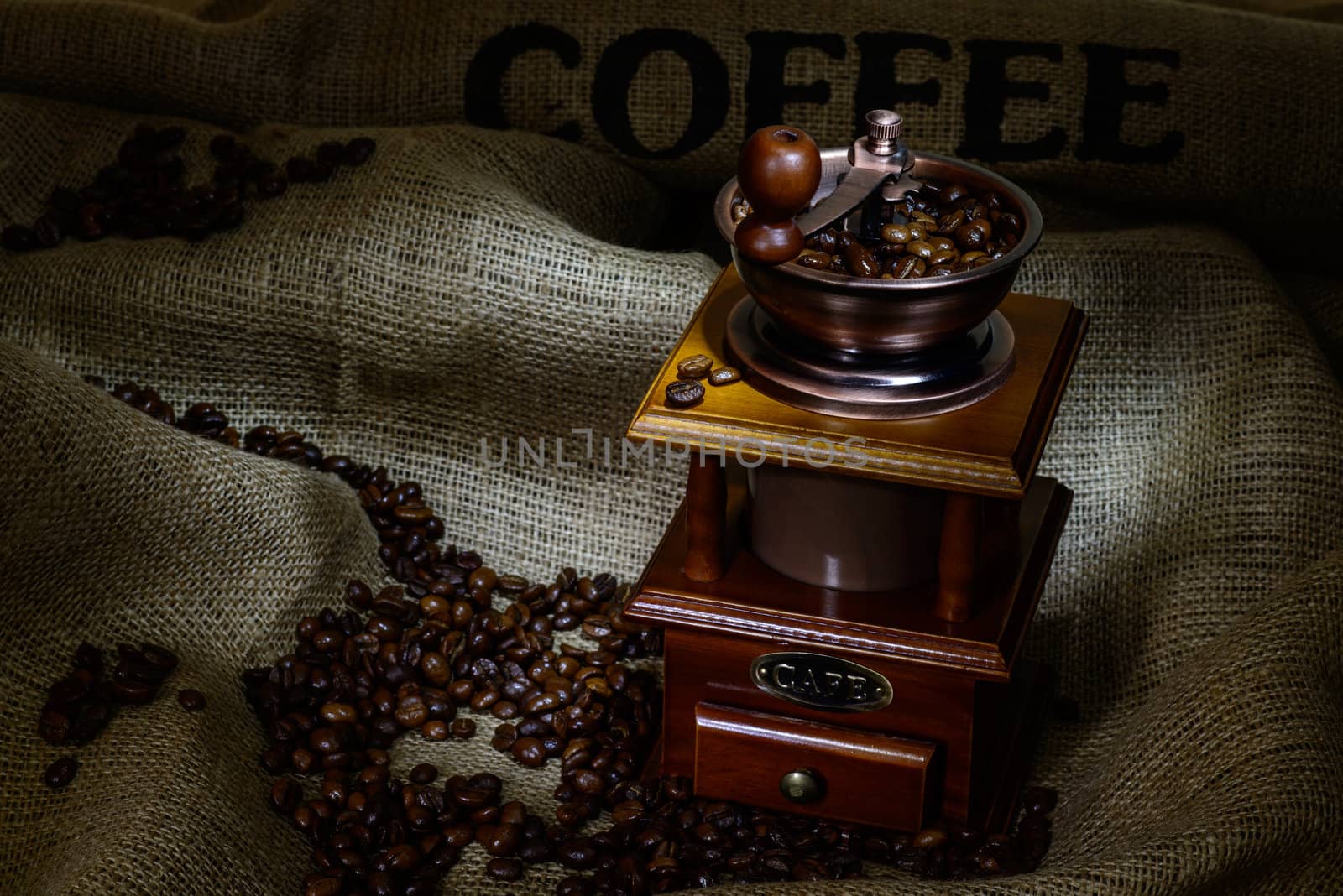 Coffee Mill with beans and burlap. still life