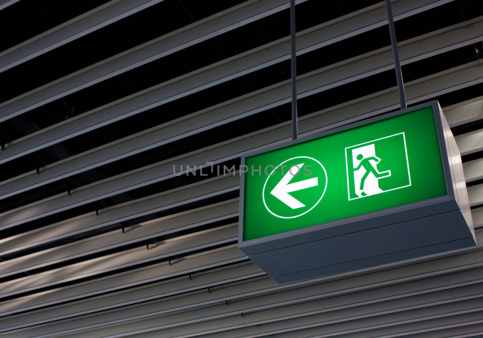 Emergency exit sign in modern offices inside an industrial plant