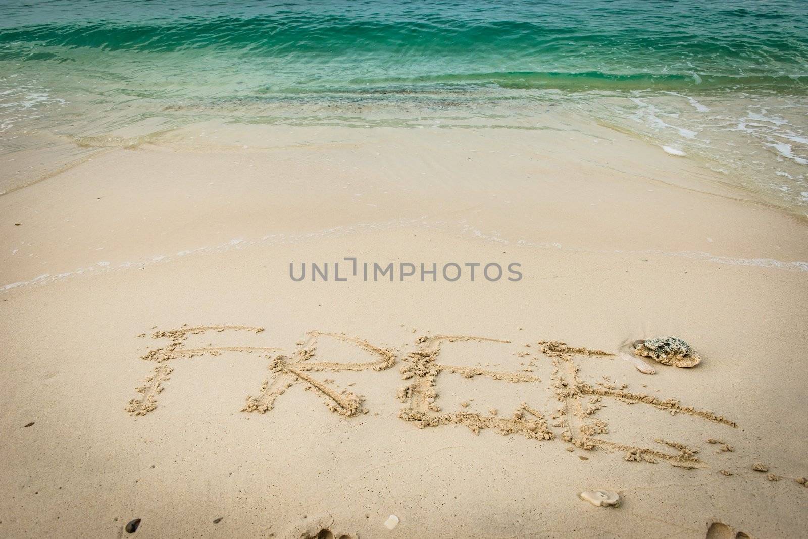 Beach on gulf of Thailand with word Free written on the sand, taken on a sunny day