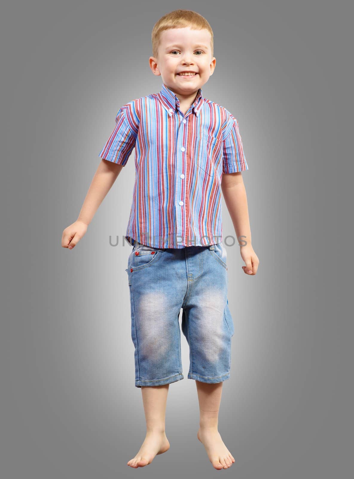 boy jumping hands up smiling and happy