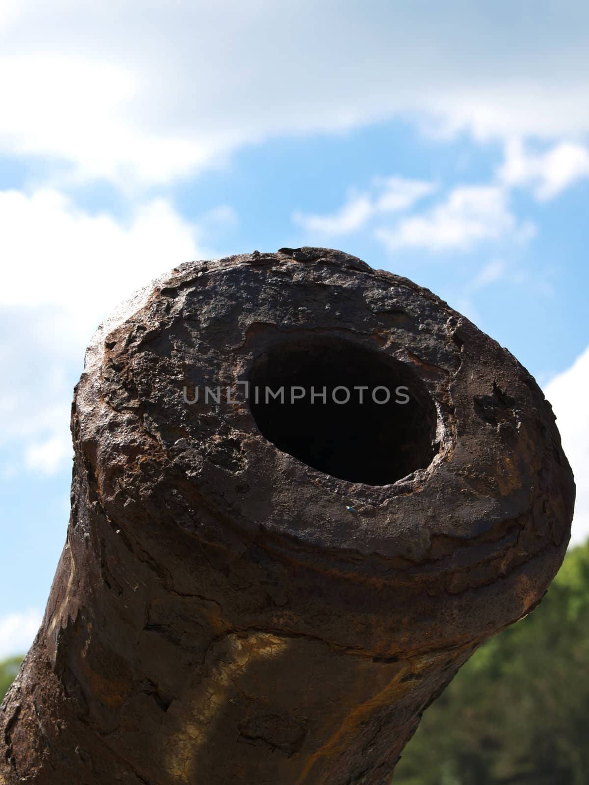 old rusty canon on the blue sky