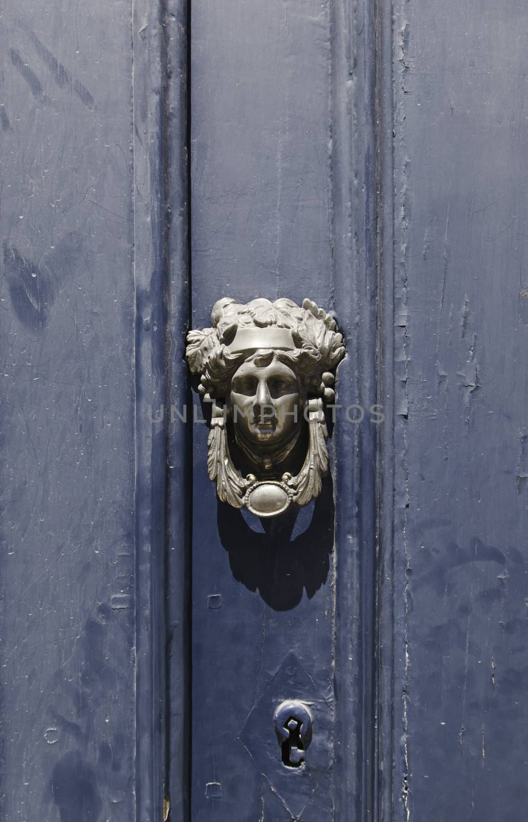 Old blue door, detail of a door knocker and lock