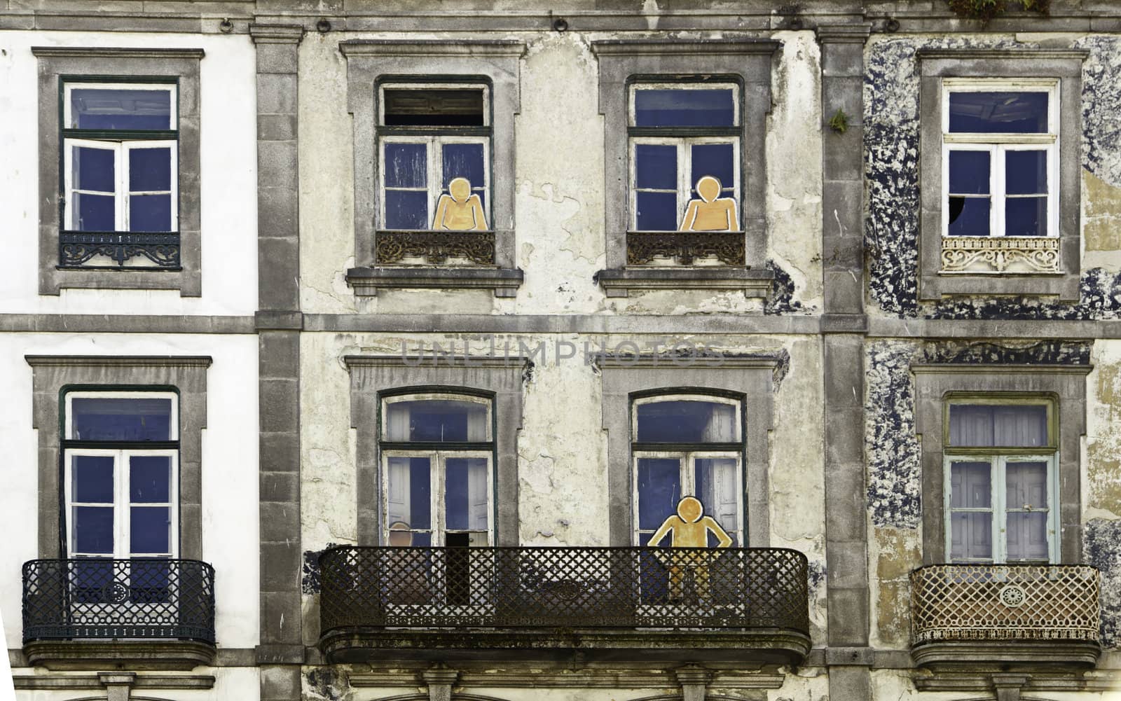 Windows with silhouettes, detail of a facade in the city of Porto, Portugal