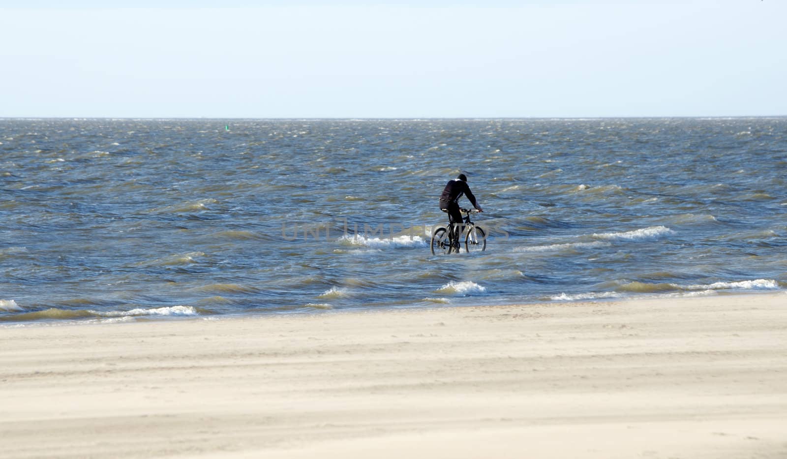 man with bike in the sea