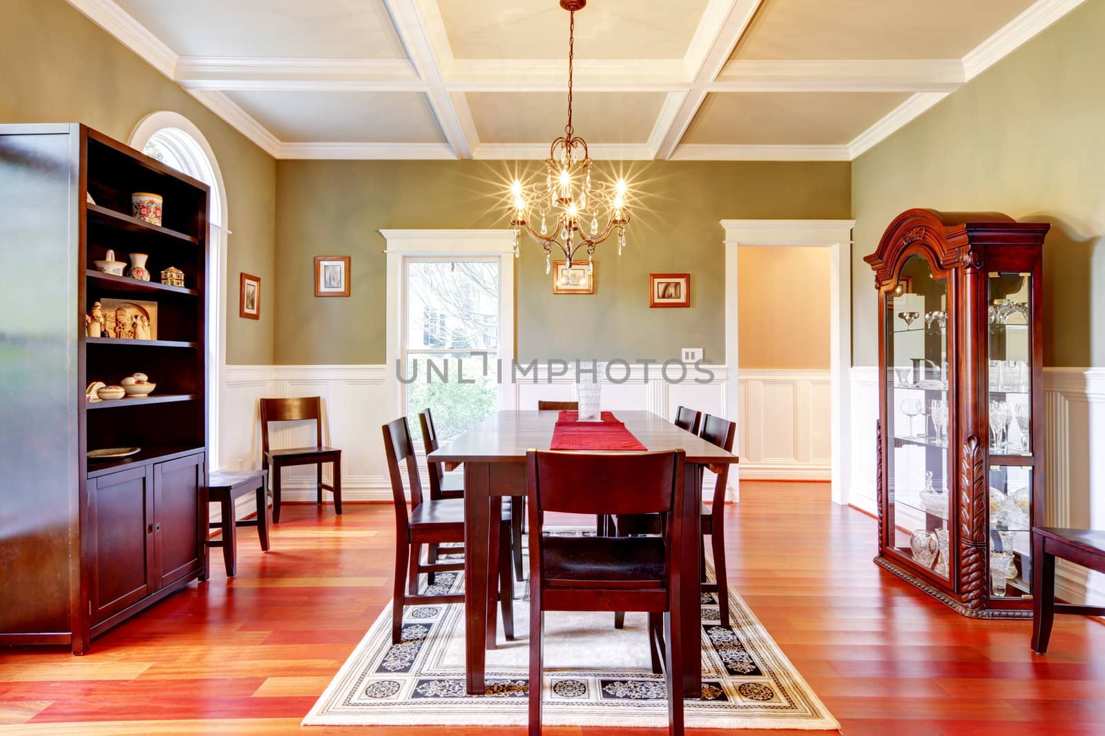 Luxury elegant green dining room with cherry floor.