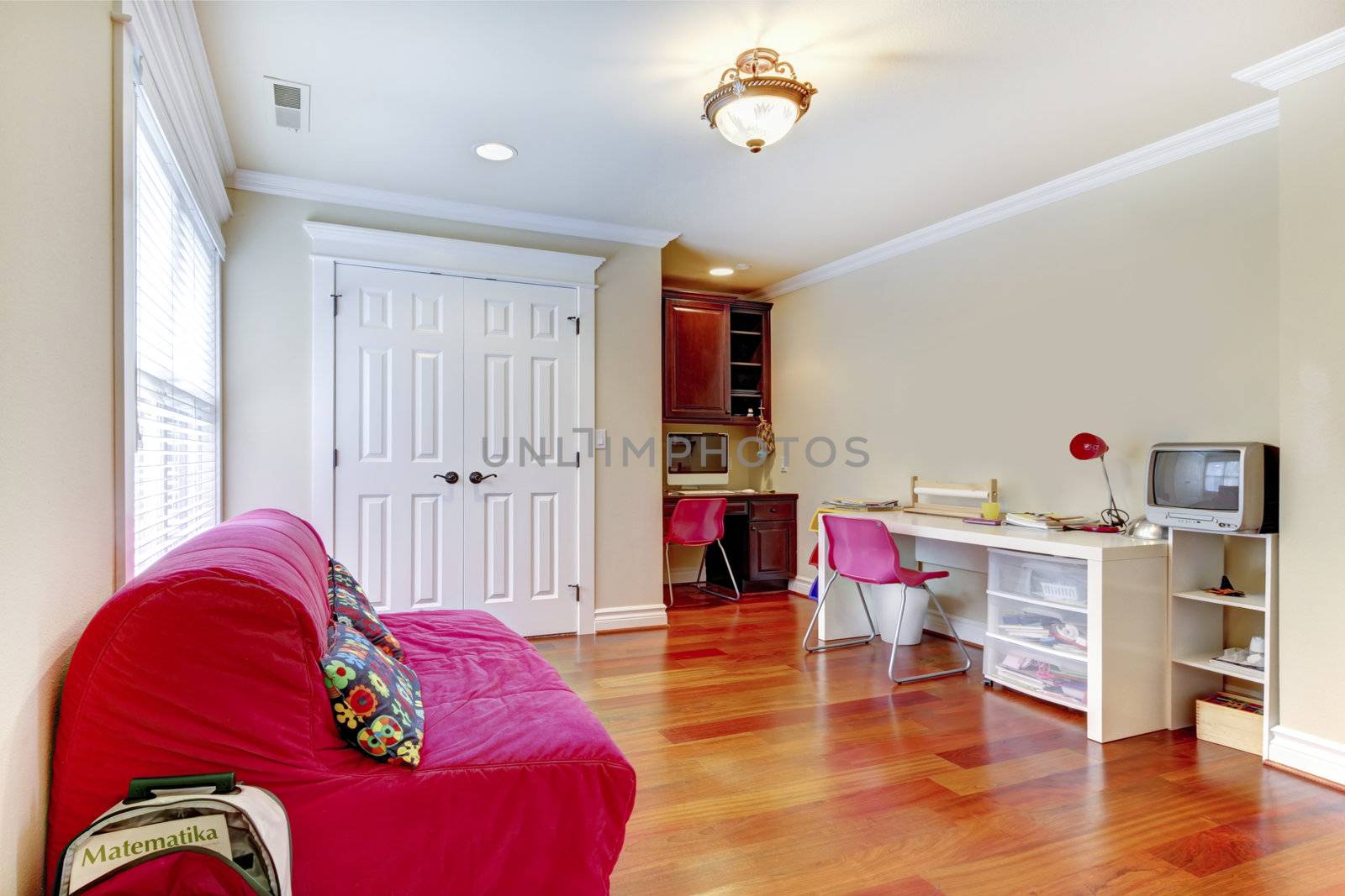 Children home study play room interior with pink sofa.