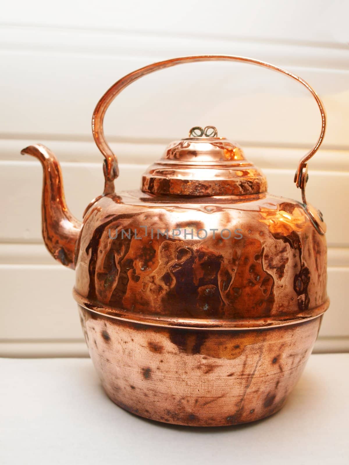 Copper tea and coffee pot, isolated towards light wood panels by Arvebettum