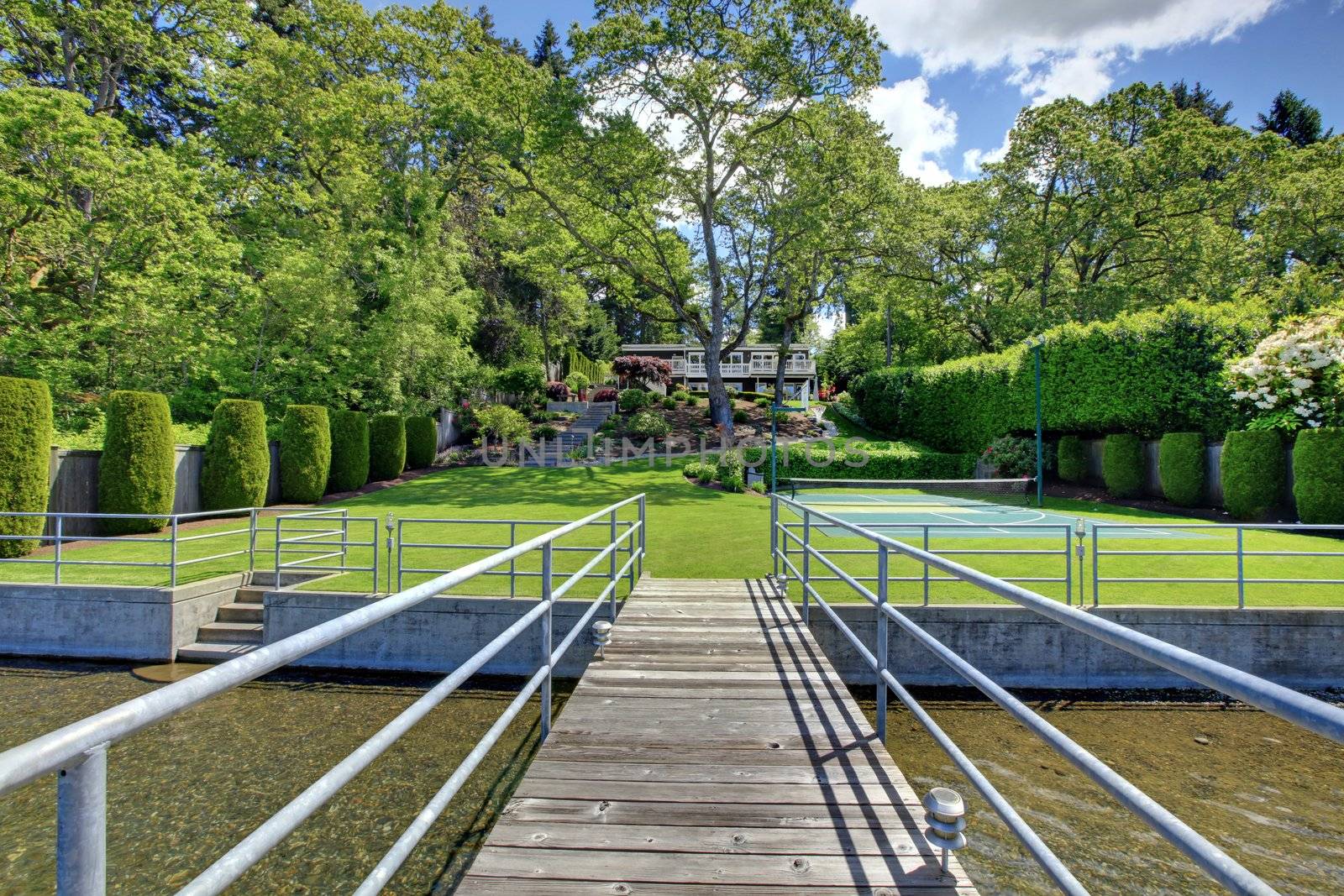 Lake with long wood pier and private party raft.