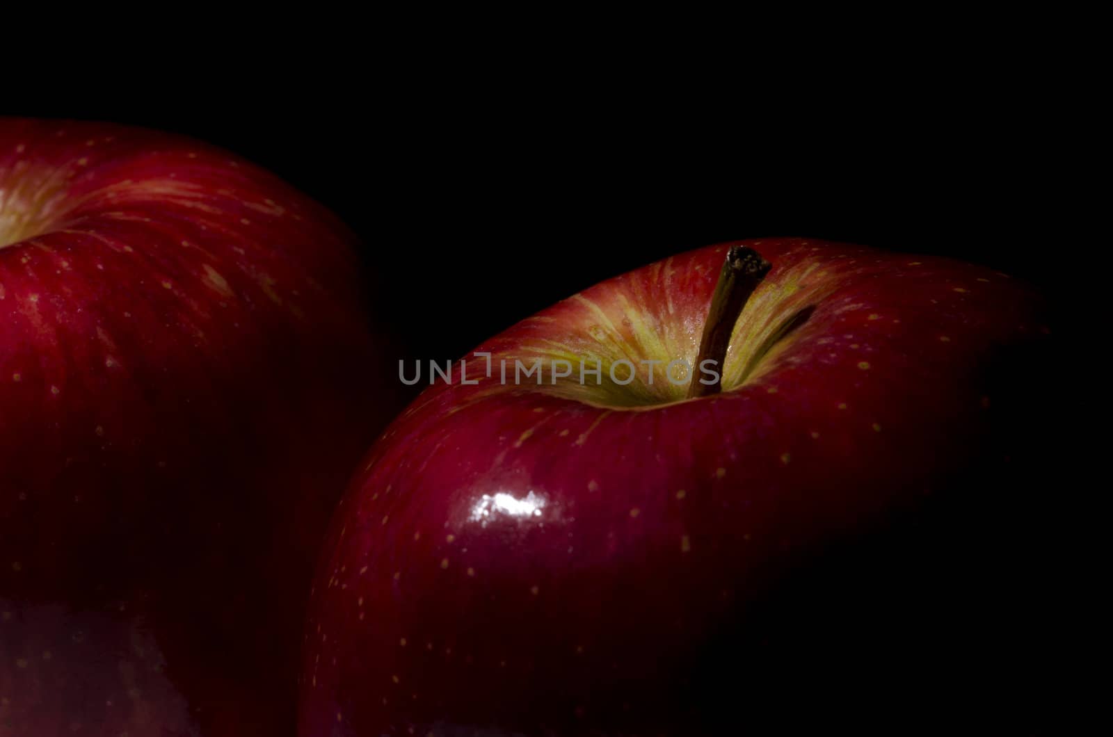 close-up of two apples on black background
