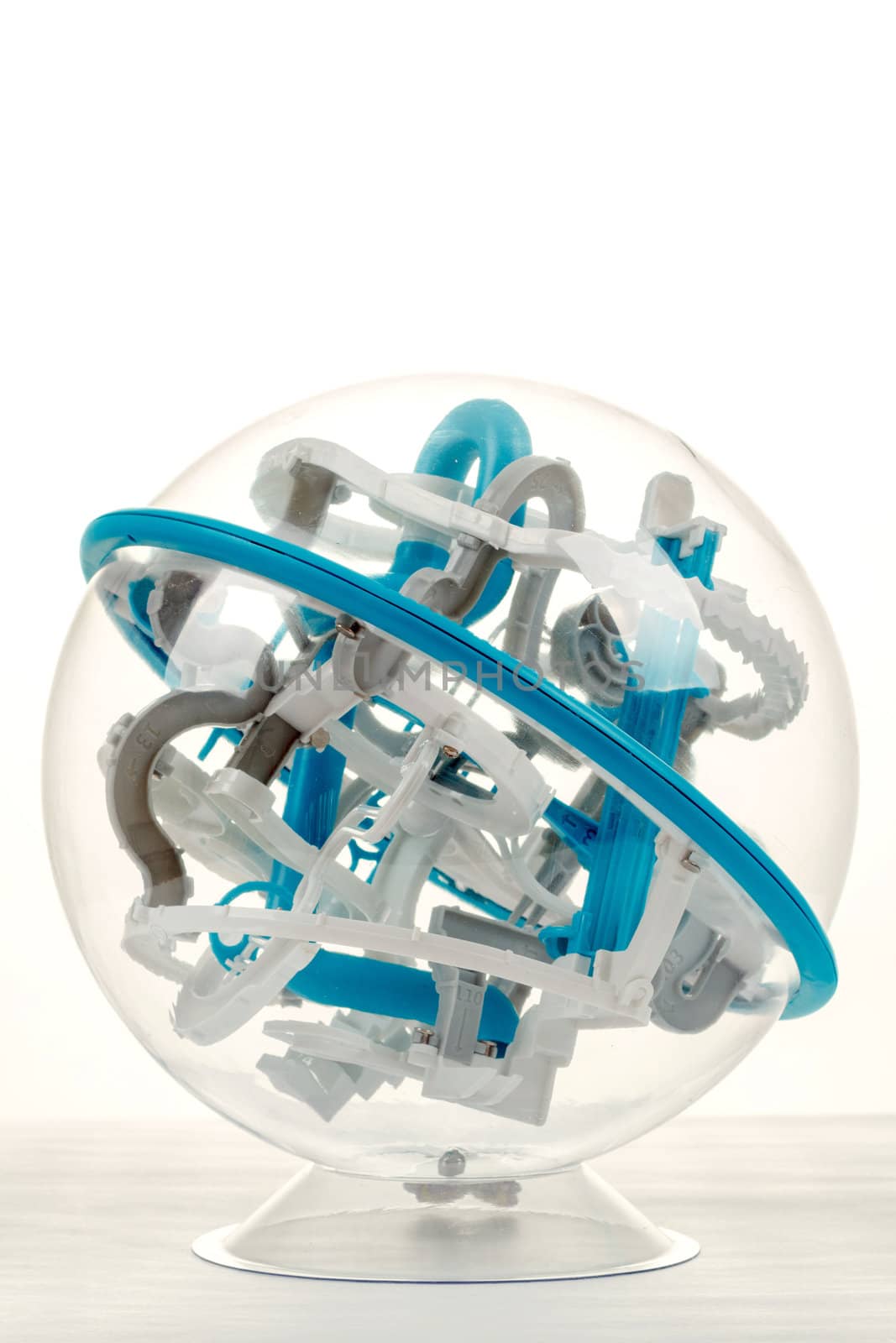 detail of 3D labyrinth ball, game on white background