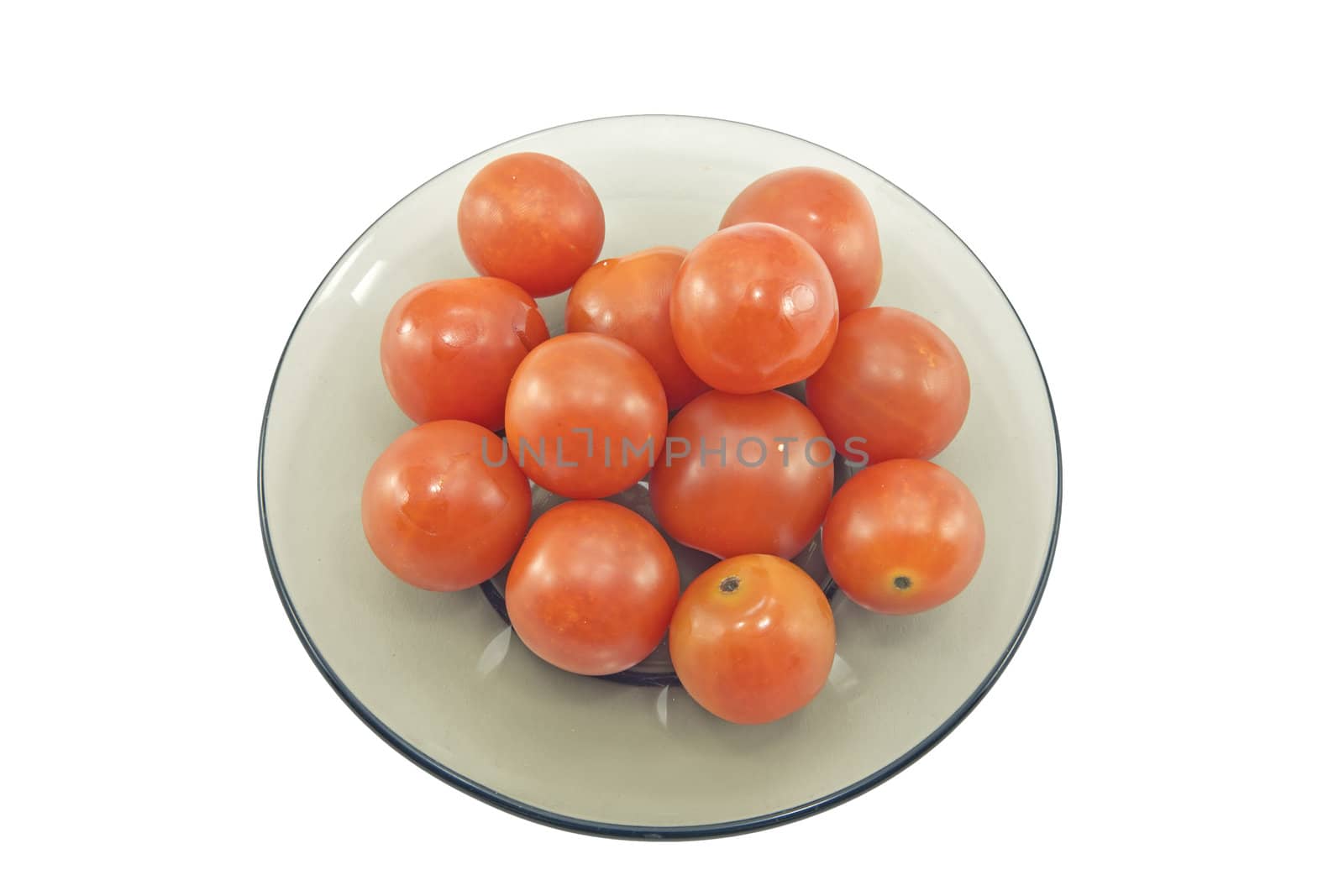 Ripe tomatoes on a glass plate