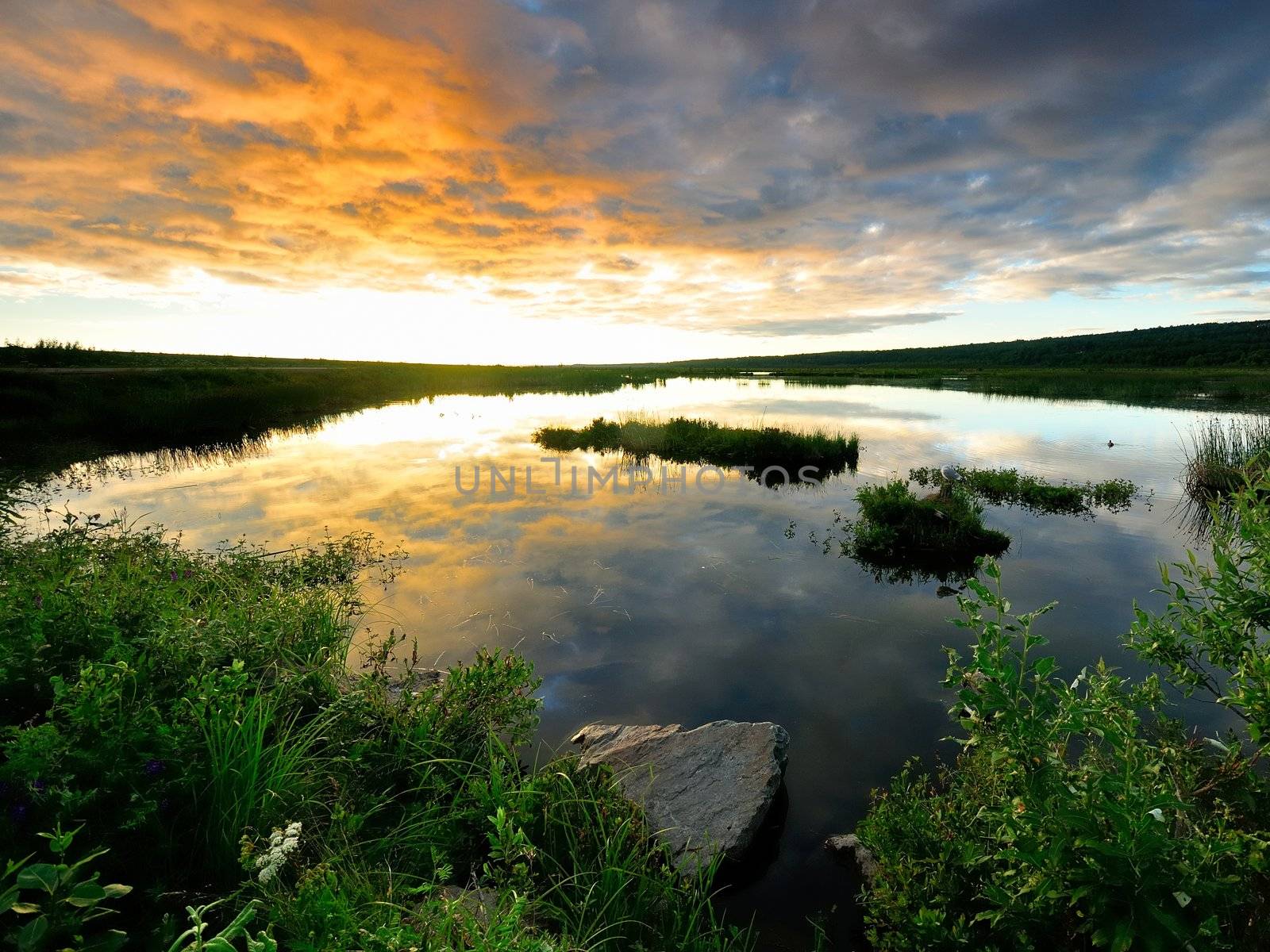 Golden sunset in Alaska with lit clouds