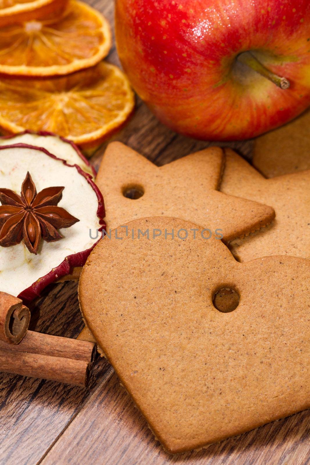 fresh apple with biscuit,cinnamon and fruit dried on wooden table
