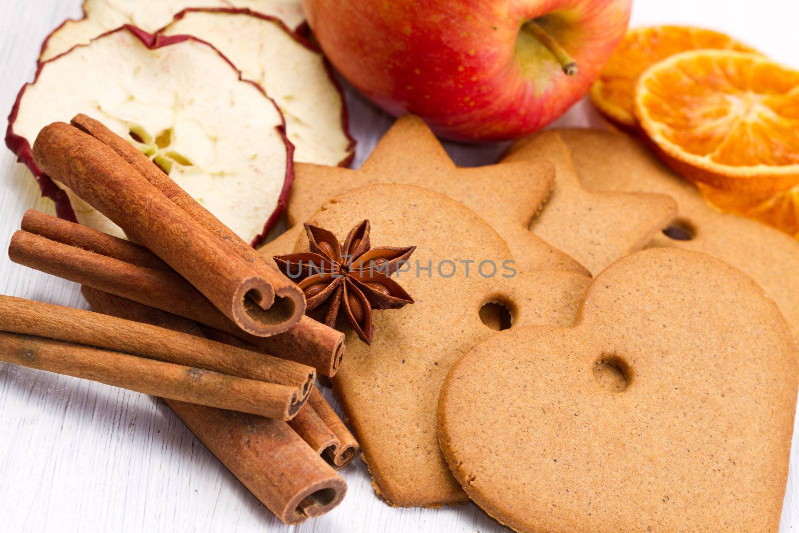 fresh apple with biscuit,cinnamon and fruit dried on white background