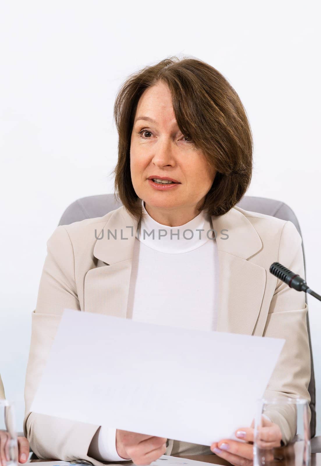 Portrait of a senior business woman, holds documents, communicates