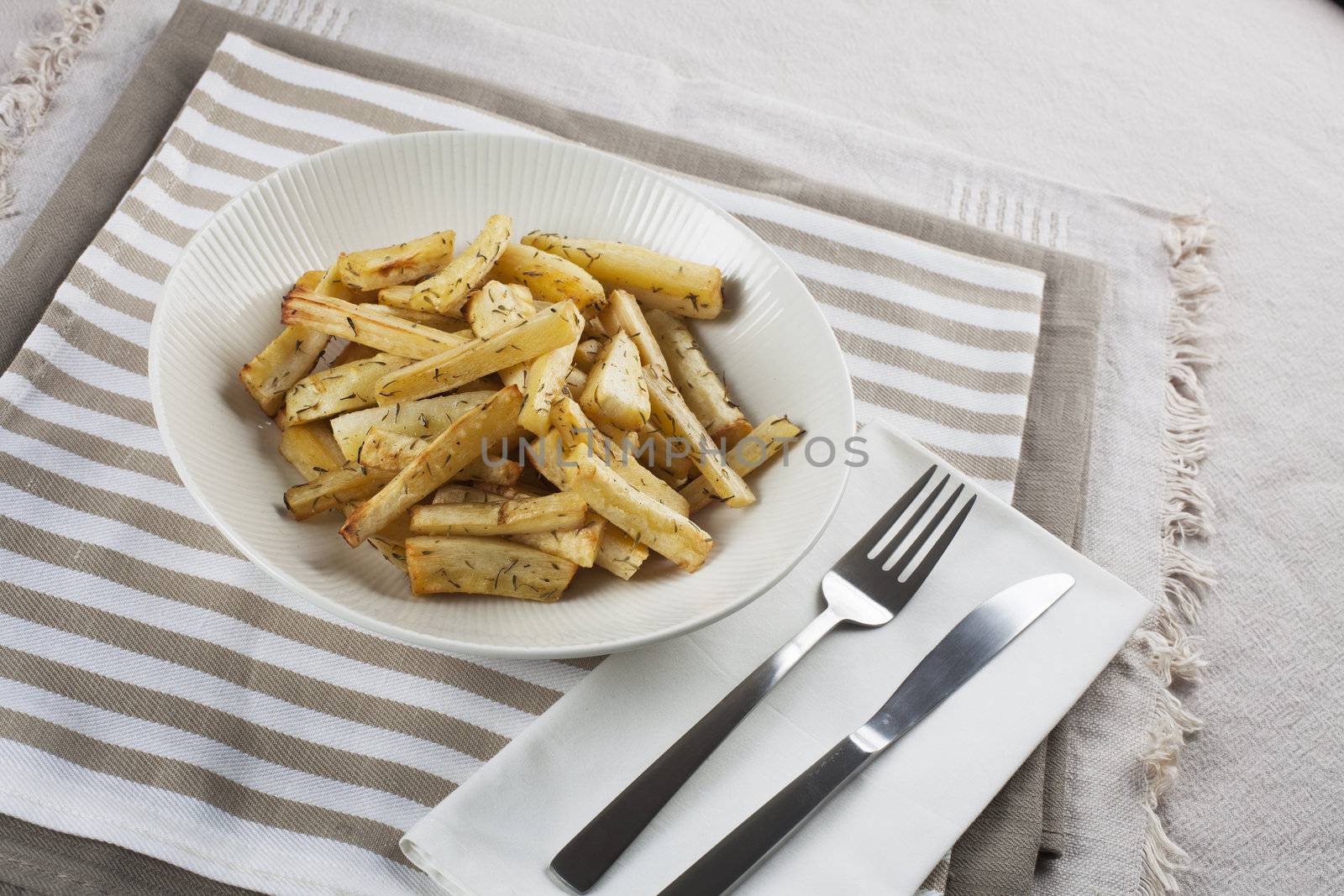 Cut roasted parsnips or potatoes with herbs.
