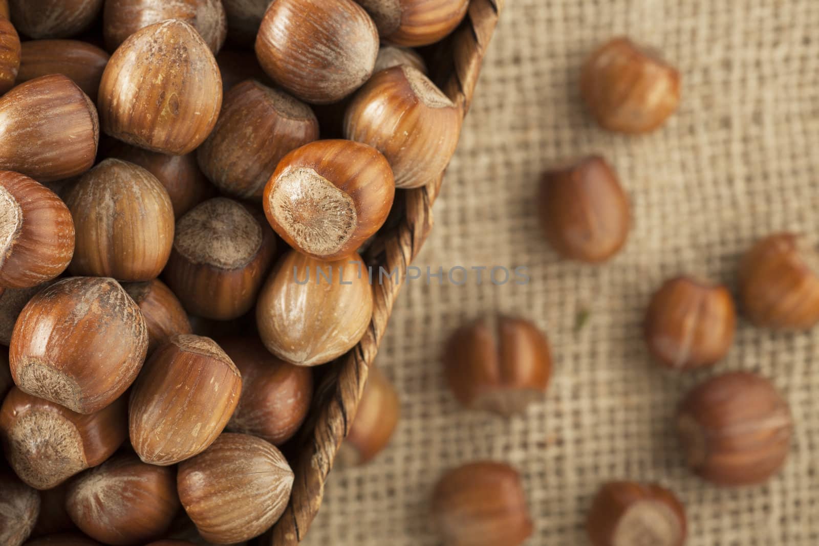 Close-up of whole unshelled hazelnuts in basket