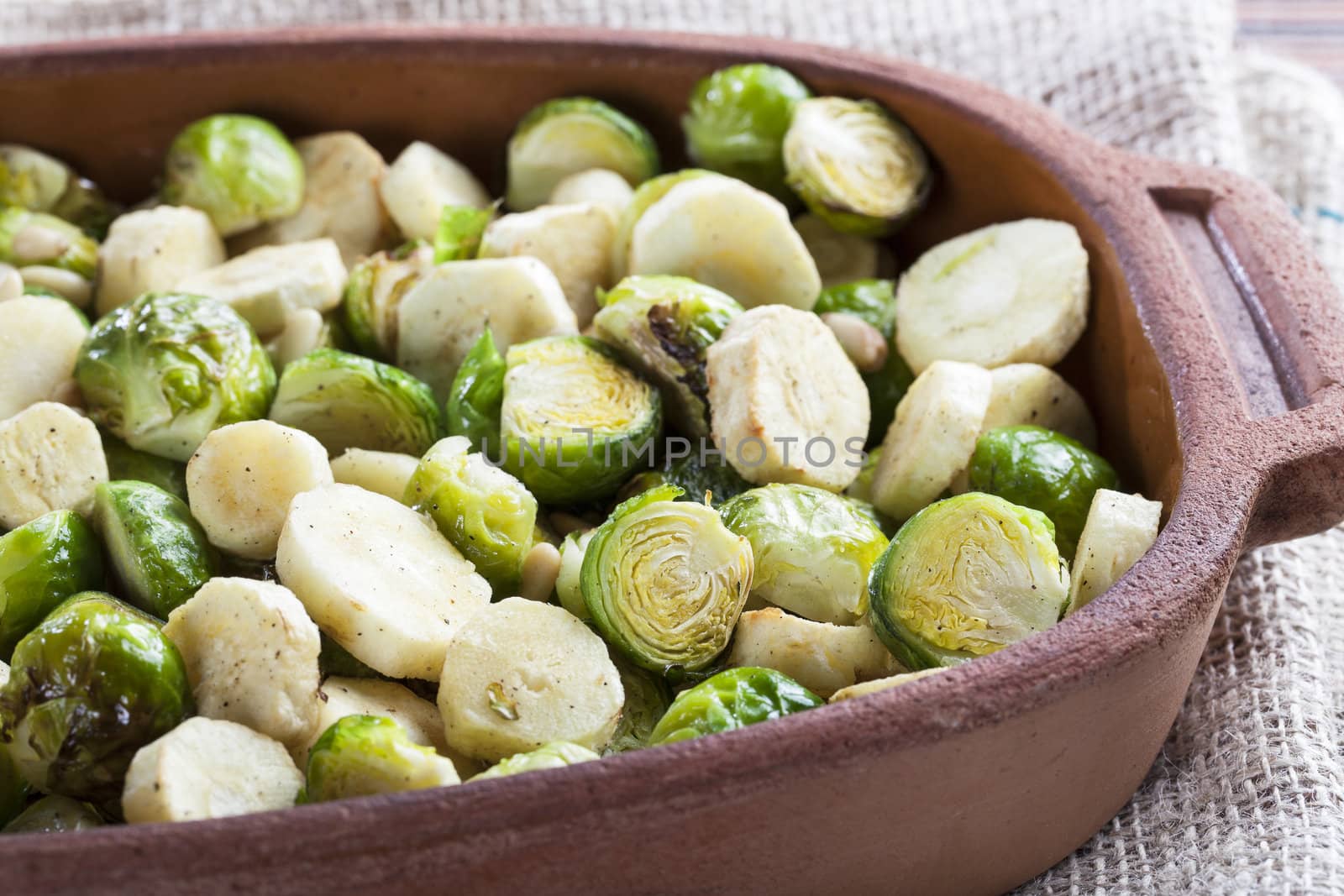 Brussels Sprouts and sliced parsnips roasted in a terracotta pan