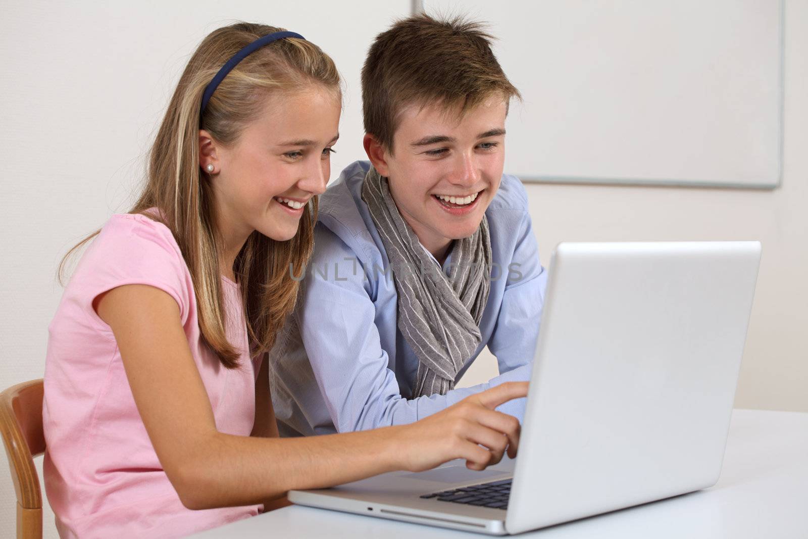 Two young students working on a laptop by sumners