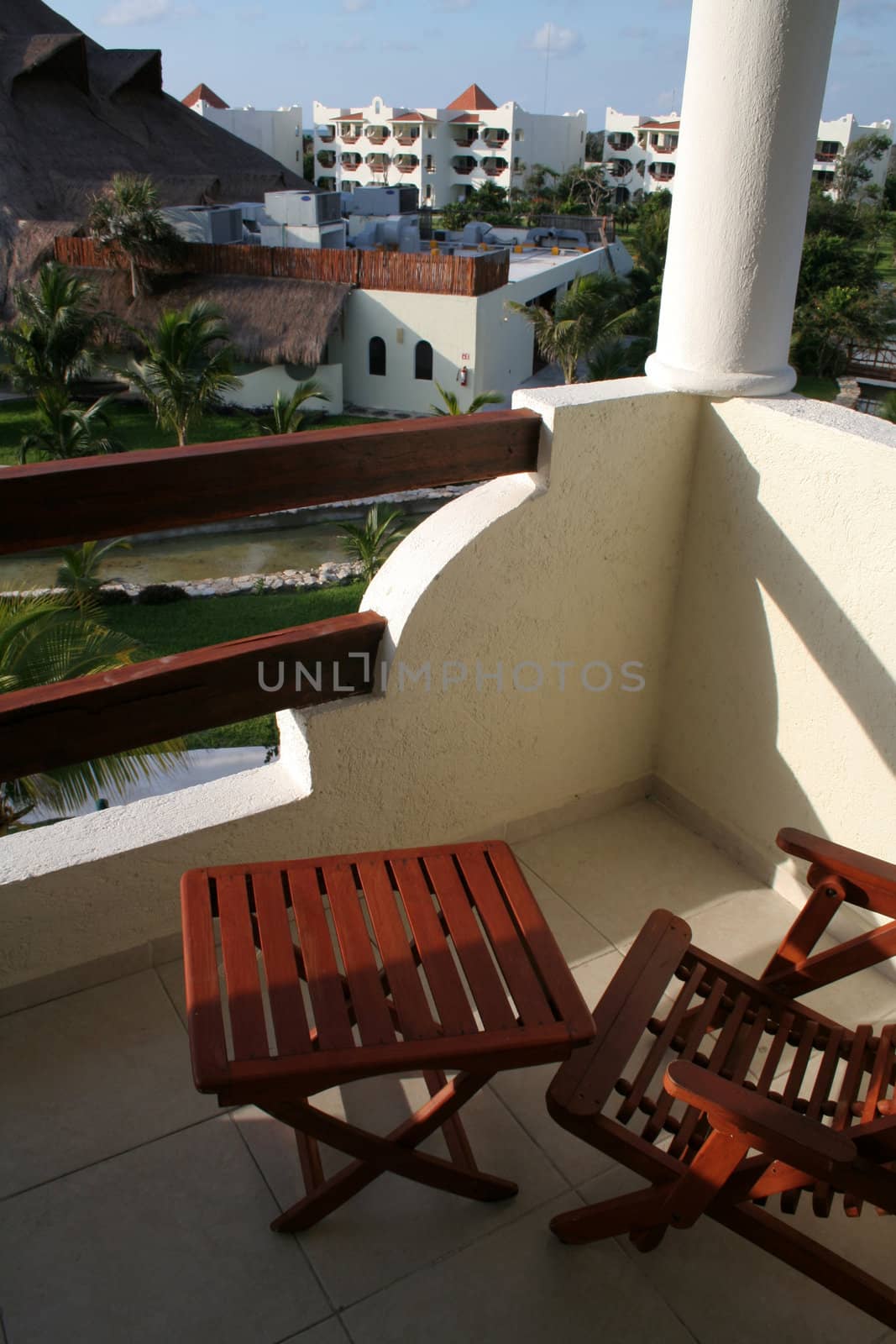 A view from the balcony of a tropical suite at a resort.