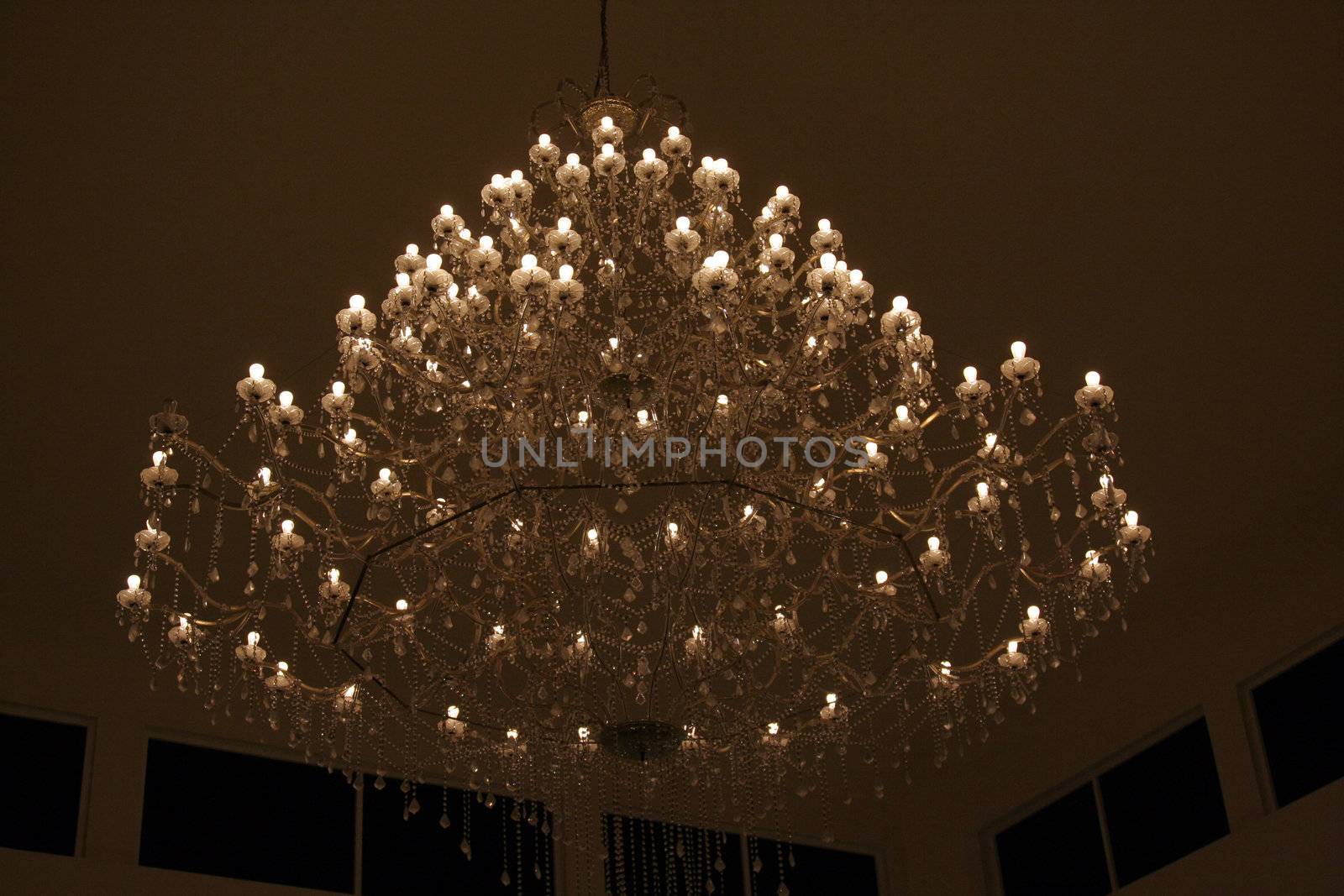 A Huge Chandelier hanging from the ceiling in a large room.