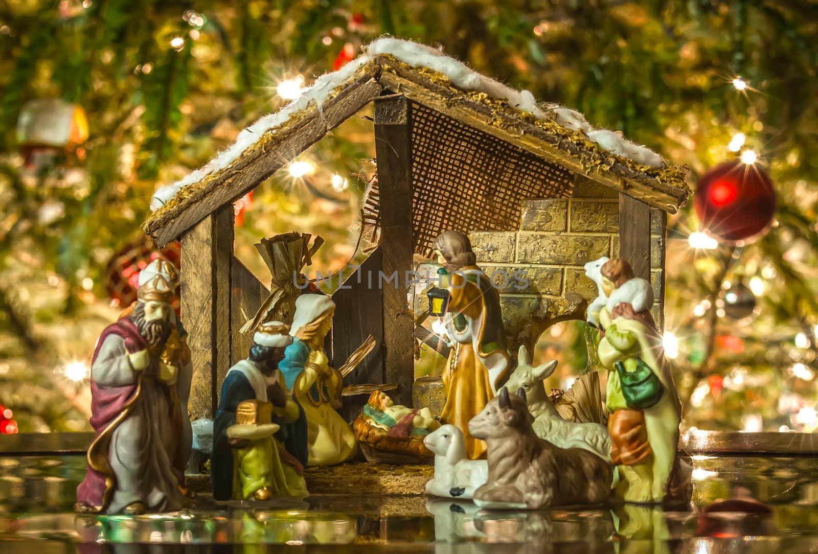 Old handmade nativity scene in front of a christmas tree by digidreamgrafix