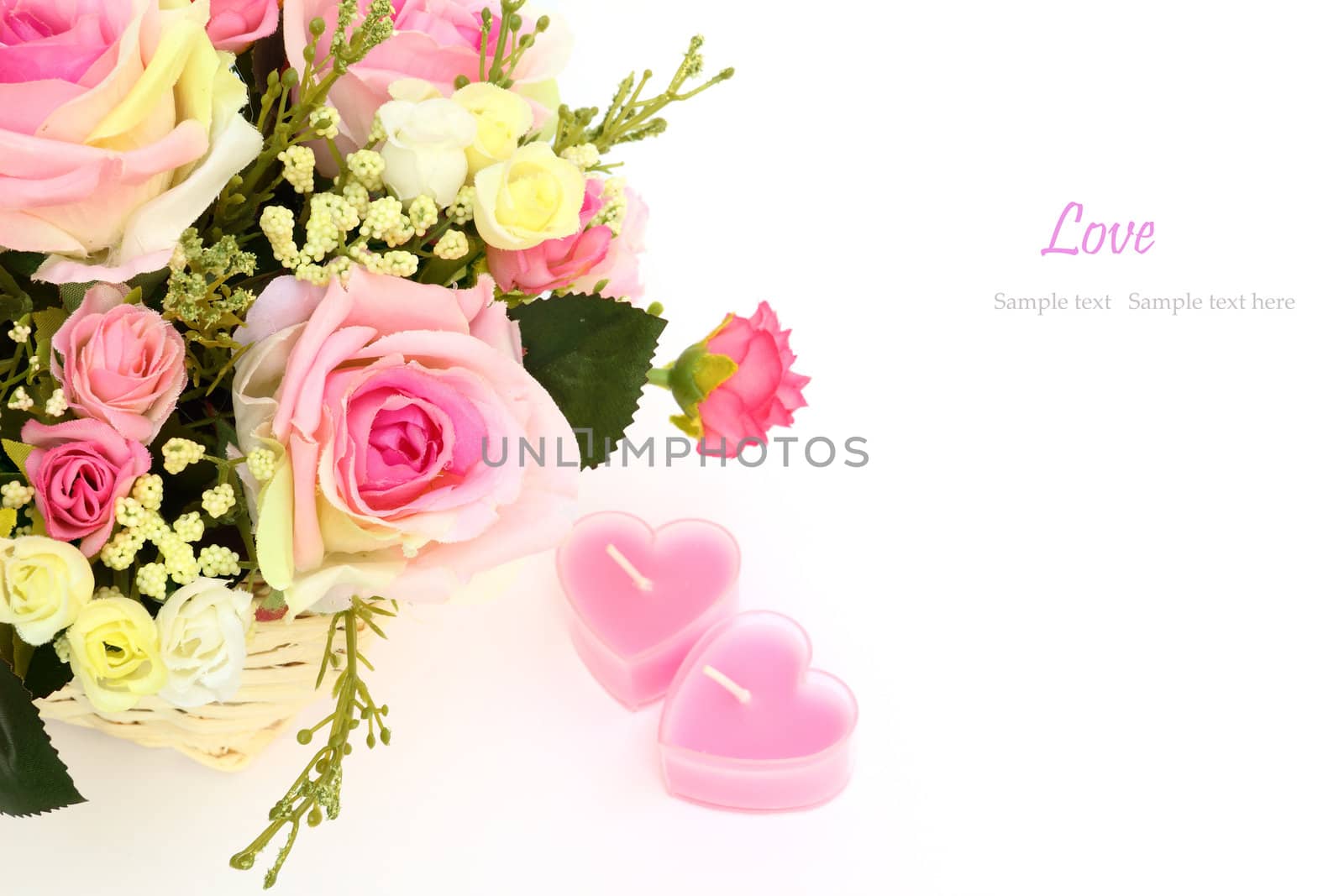Beautiful flowers in a white basket and two heart candles isolated on white with space for text.