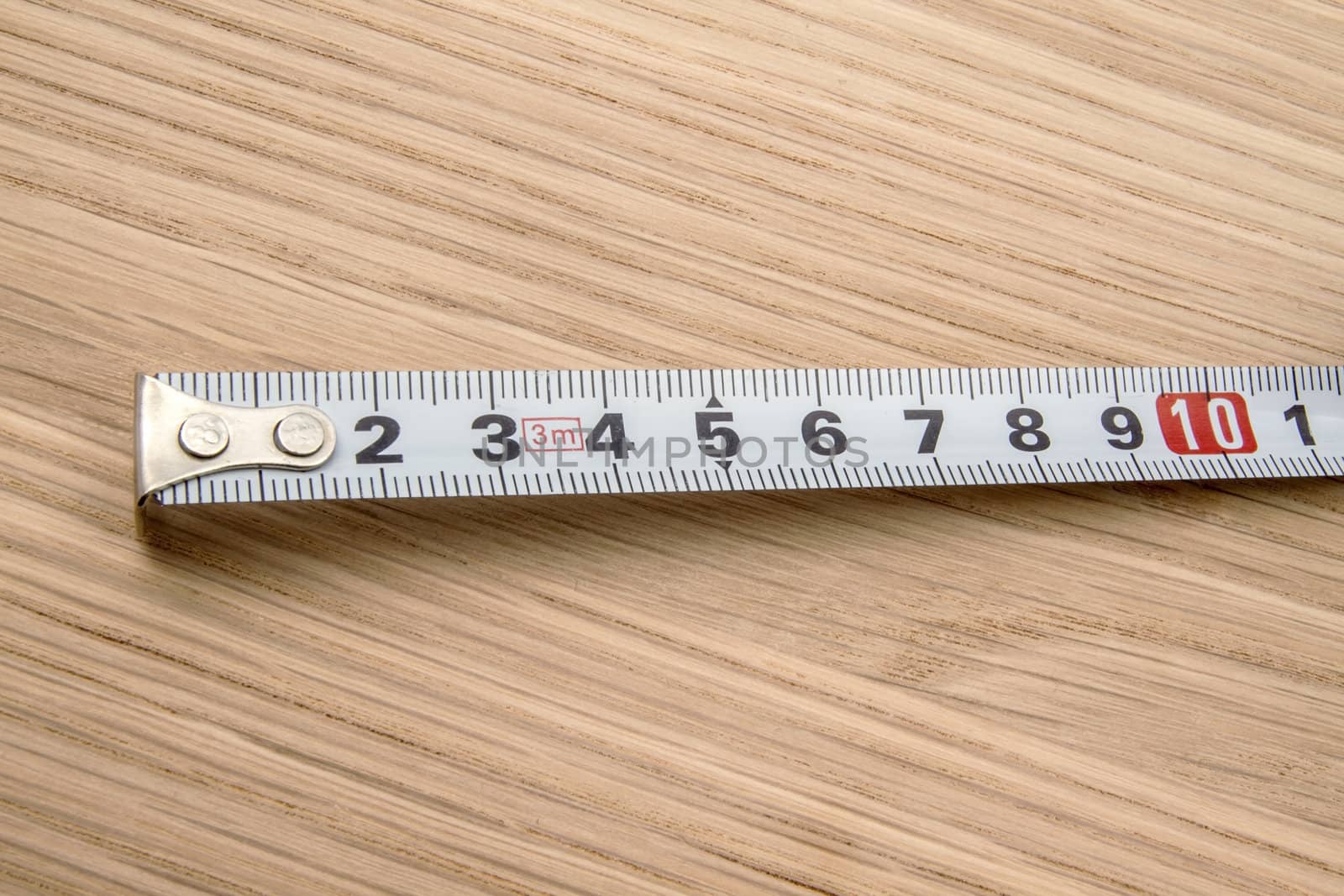 Tape measure closeup on wood background 