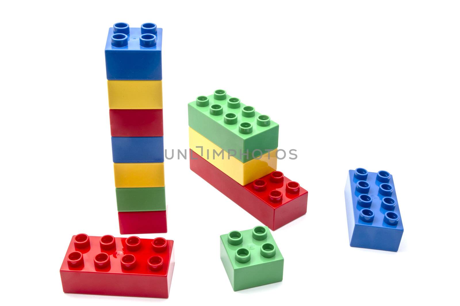 Colorful building blocks closeup on white background 