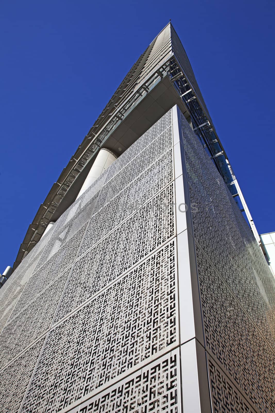 Perspective and underside angle view of modern glass building skyscrapers over blue sky 